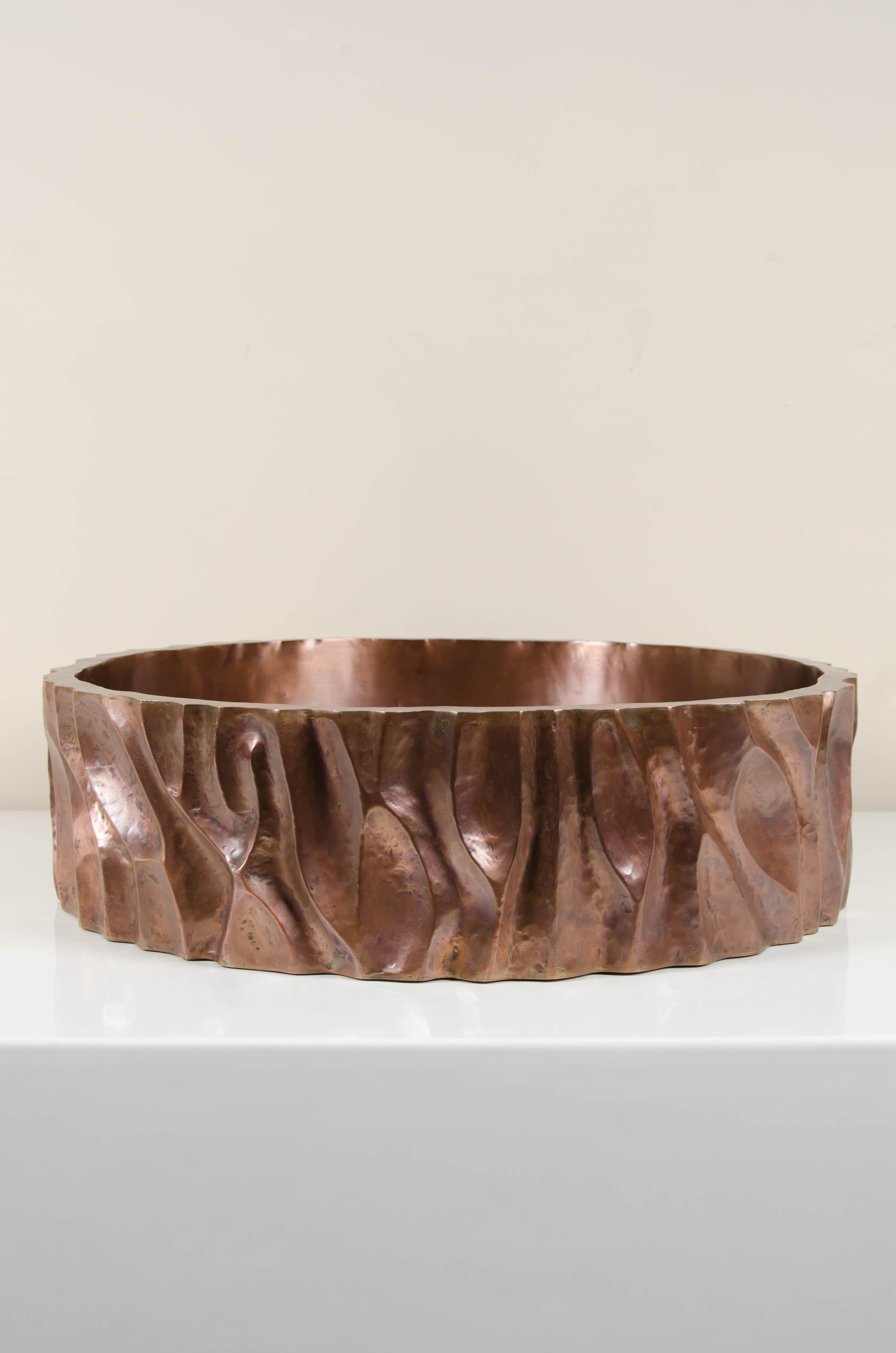 Low tree trunk cachepot
Antique copper
Hand repoussé
Limited edition.

Repoussé is the traditional art of hand-hammering decorative relief onto sheet metal. The technique originated circa 800 BC between Asia and Europe and in Chinese historical