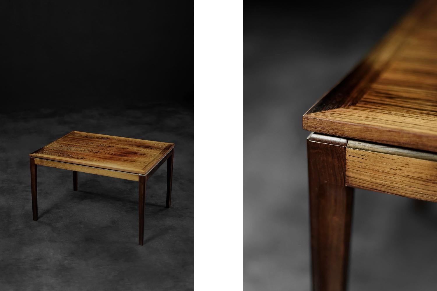 Dieser niedrige Couchtisch wurde in den 1960er Jahren in Dänemark hergestellt. Der geometrische Tisch ist aus edlem Palisanderholz in einem dunklen Braunton mit sichtbarer, reicher Maserung gefertigt. Der Sockel besteht aus schlanken, geschnitzten