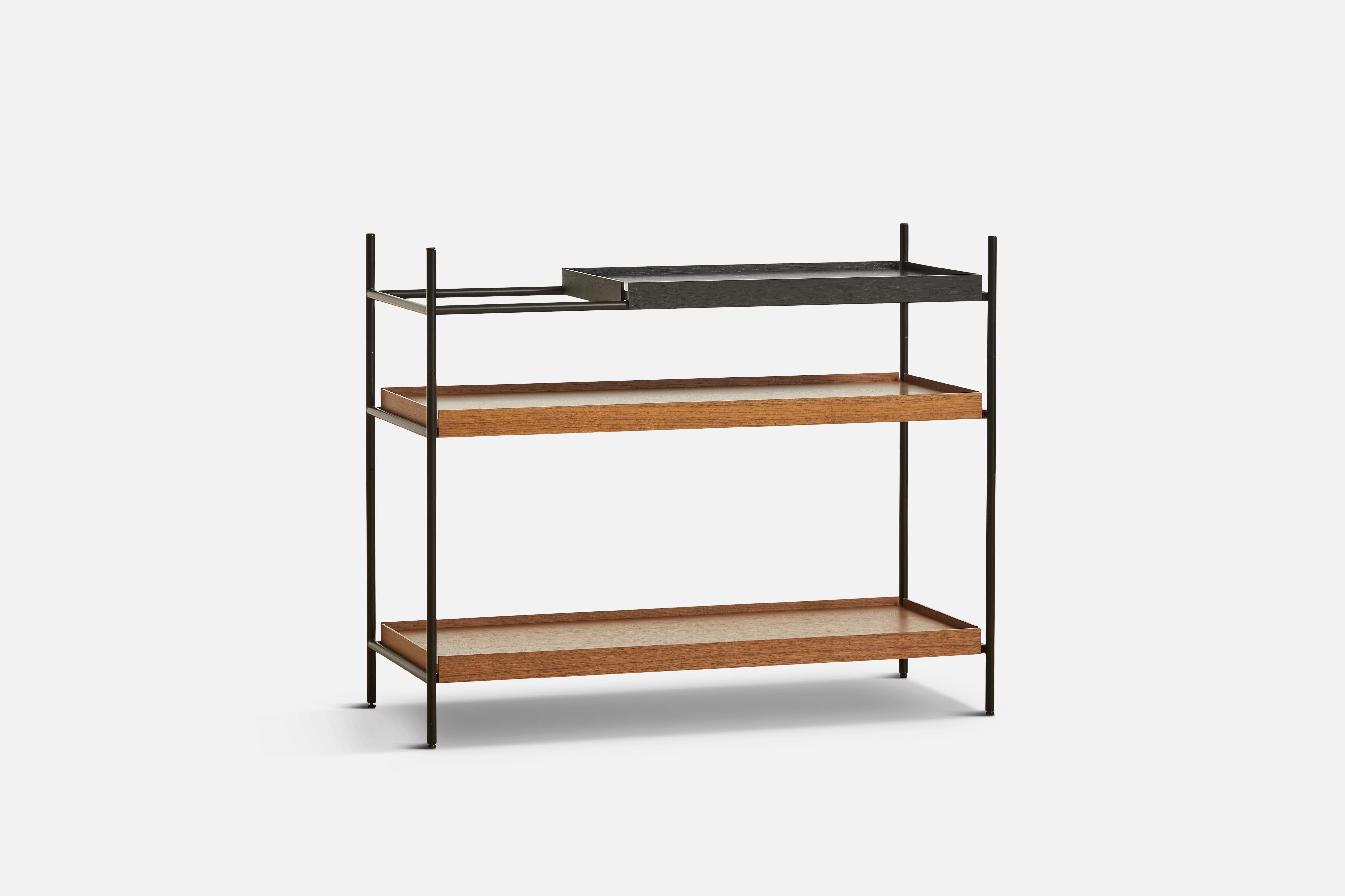 Low walnut and black tray shelf I by Hanne Willmann
Materials: metal, walnut.
Dimensions: D 40 x W 100 x H 81 cm
Also available in different tray conbinations and 2 sizes: H 81, H 201 cm.

Hanne Willmann is a dynamic German designer with her
