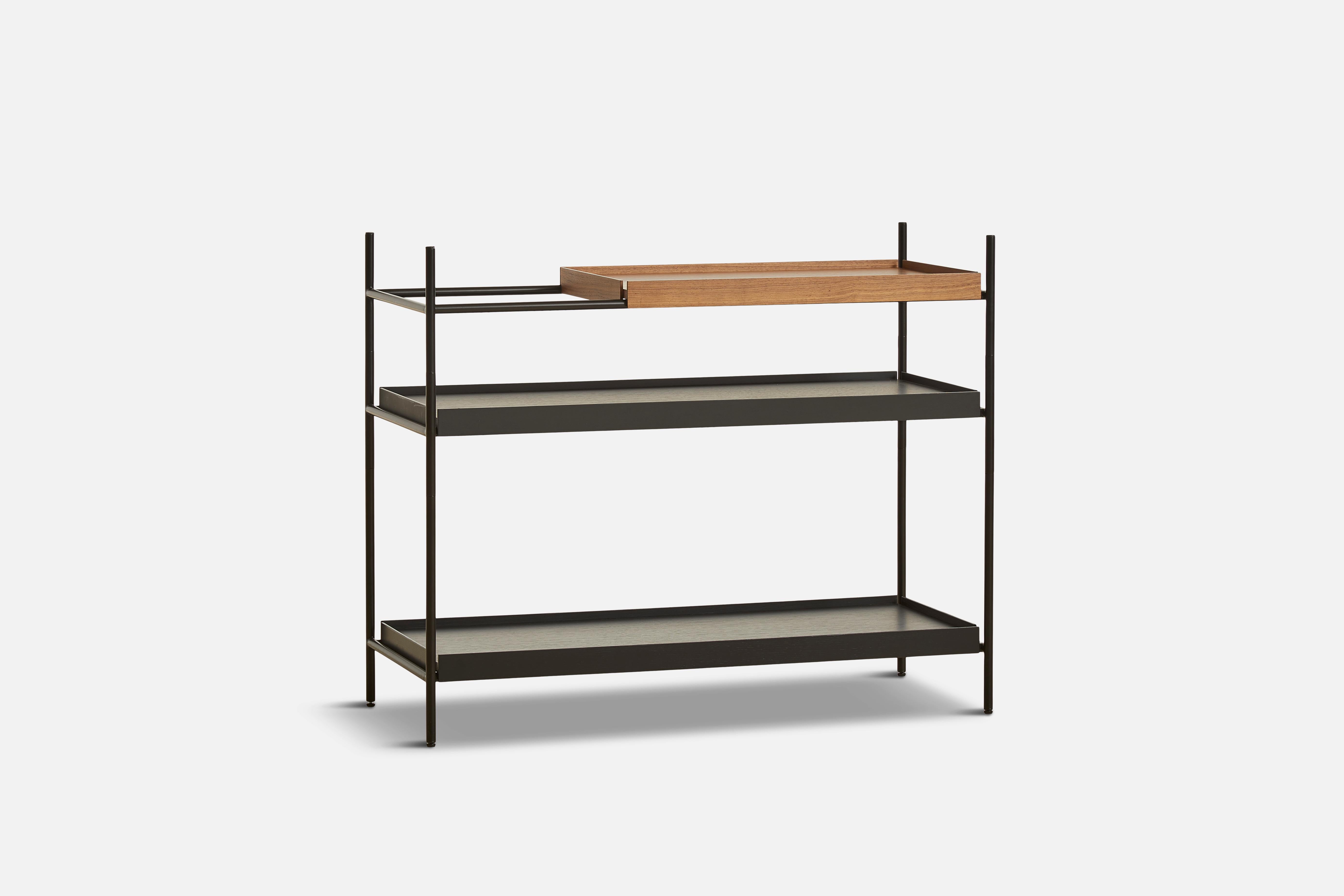Low walnut and black tray shelf II by Hanne Willmann
Materials: metal, walnut.
Dimensions: D 40 x W 100 x H 81 cm.
Also available in different tray combinations and 2 sizes: H81, H 201 cm.

Hanne Willmann is a dynamic German designer with her