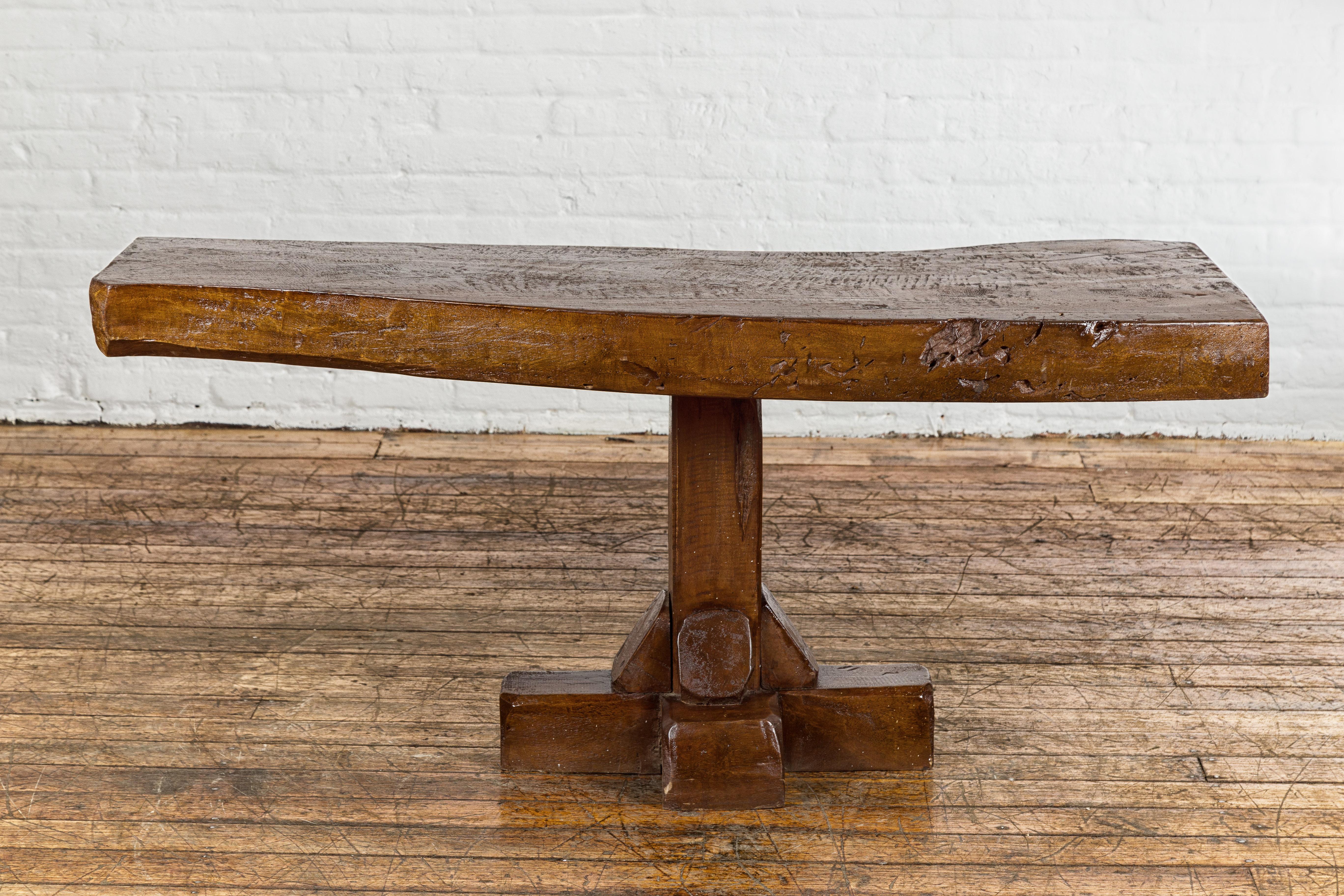 Carved Low Wooden Console Table with Rustic Top and Pedestal Base For Sale
