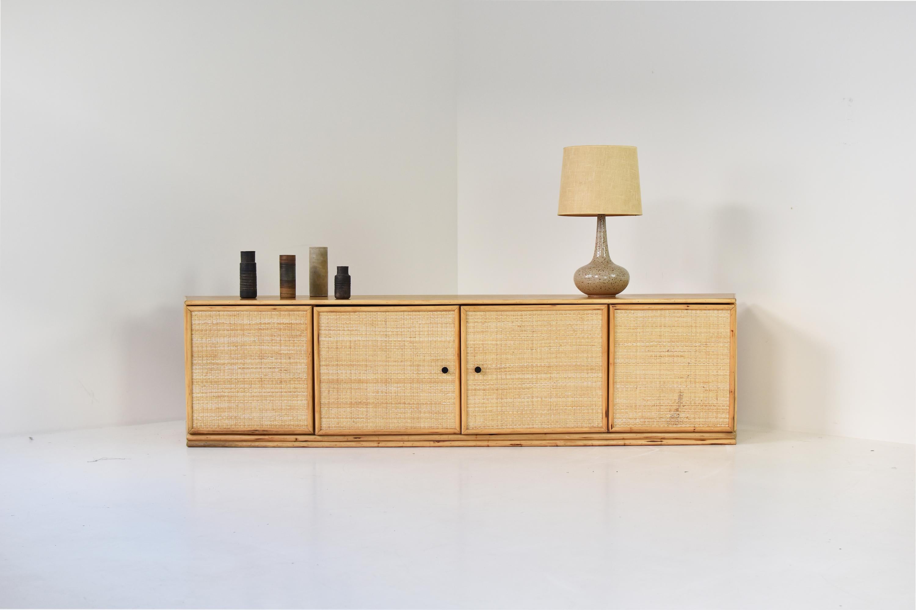 Lowboard in oak and cane from the 1960s. This low sideboard has 4 open doors revealing plenty of storage room. Slightly different color on top. Can be restored by our cabinetmaker upon request. Good vintage condition.