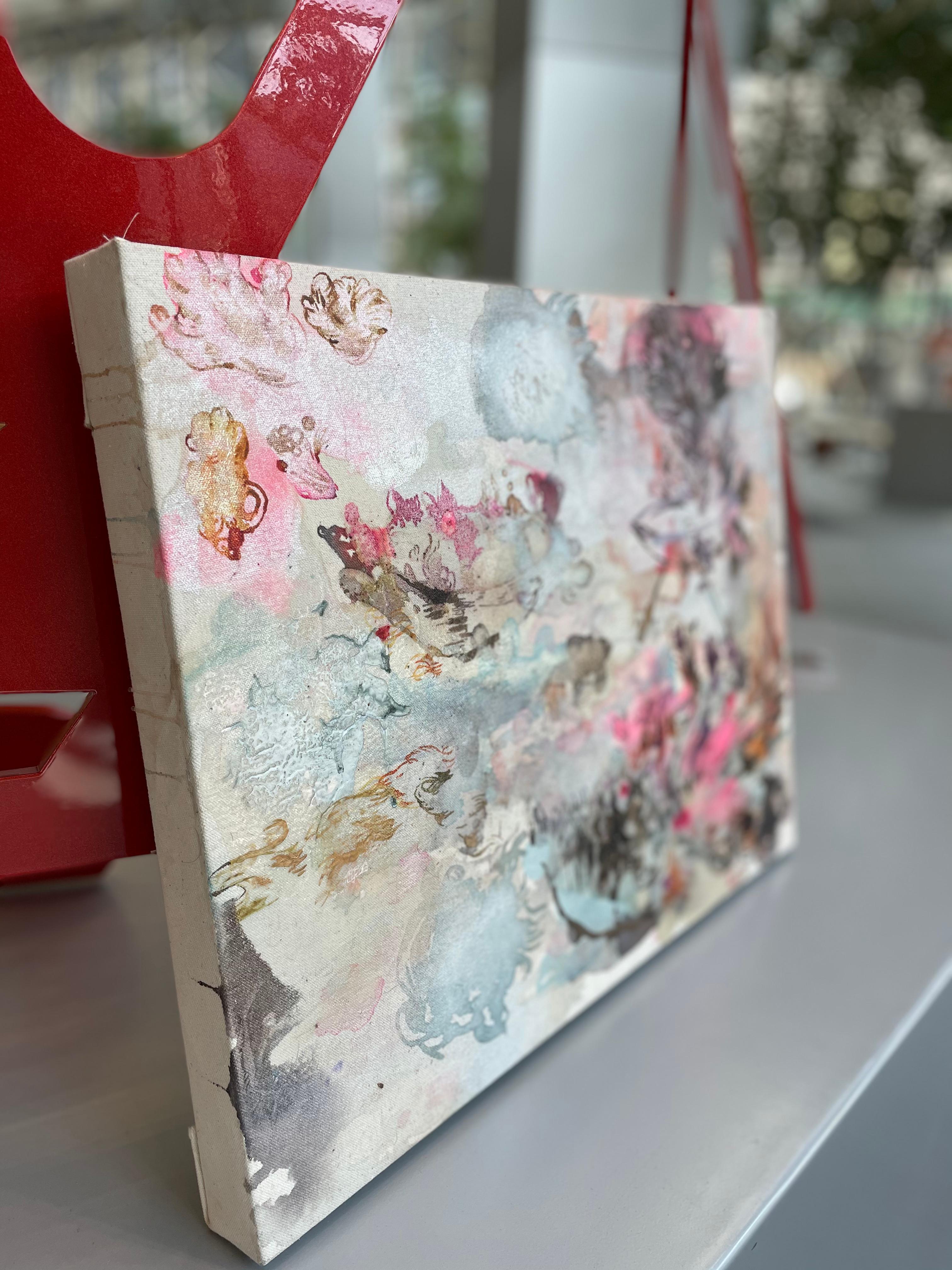 “Vessels” seems bigger than its scale. It opens to an expansive world for the viewer using diaphanous pinks and touches of silver and pearlescent, shimmering acrylic paints, resins and inks on canvas. Gently rendered vessels, as if born from shapes