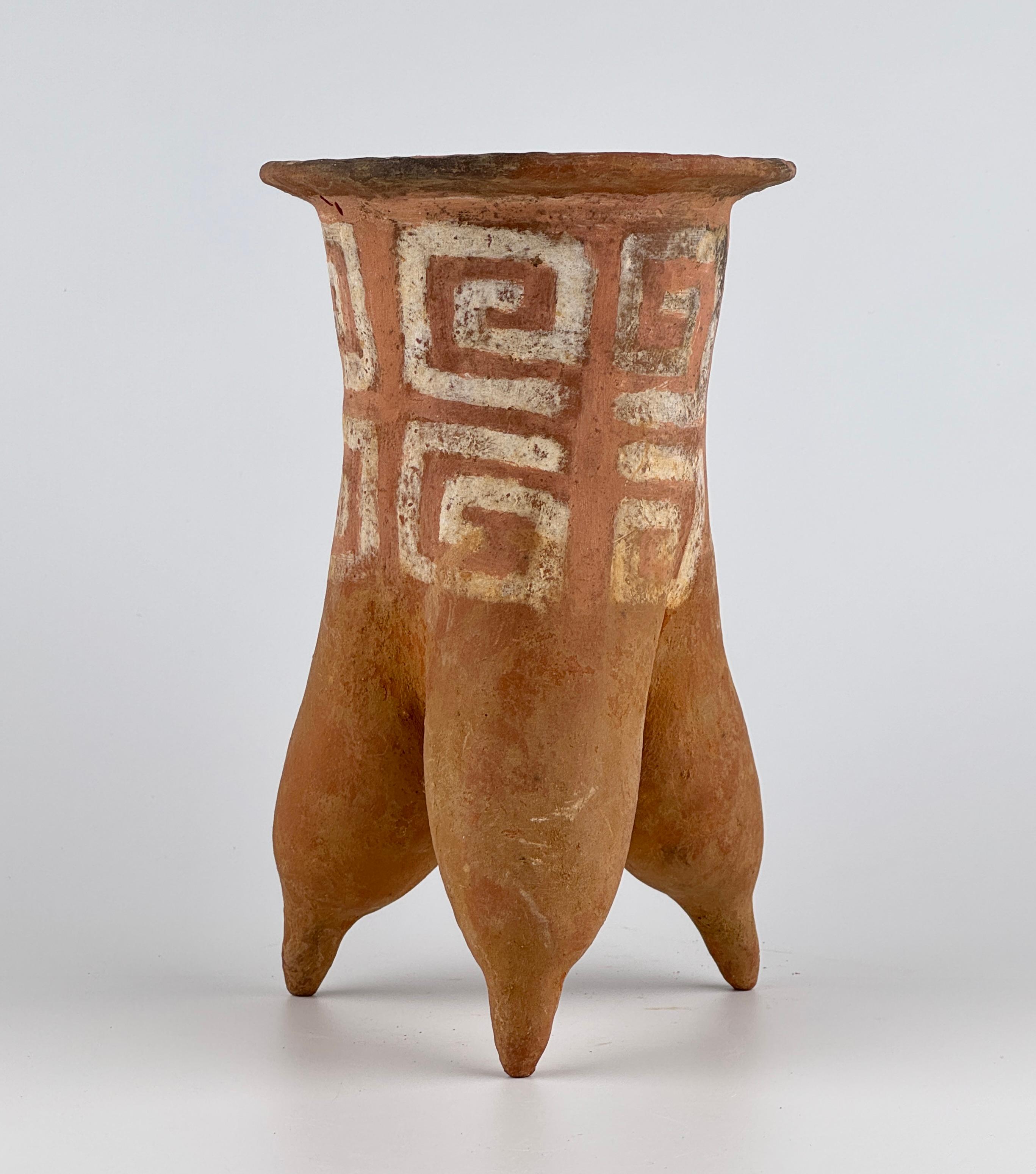 This tripod jar, dating from 2000 to 1500 BCE, is attributed to the Lower Xiajiadian Culture, which flourished in Northeast China. It exemplifies the early ceramic craftsmanship of Neolithic agricultural societies. Made from low-fired clay, the