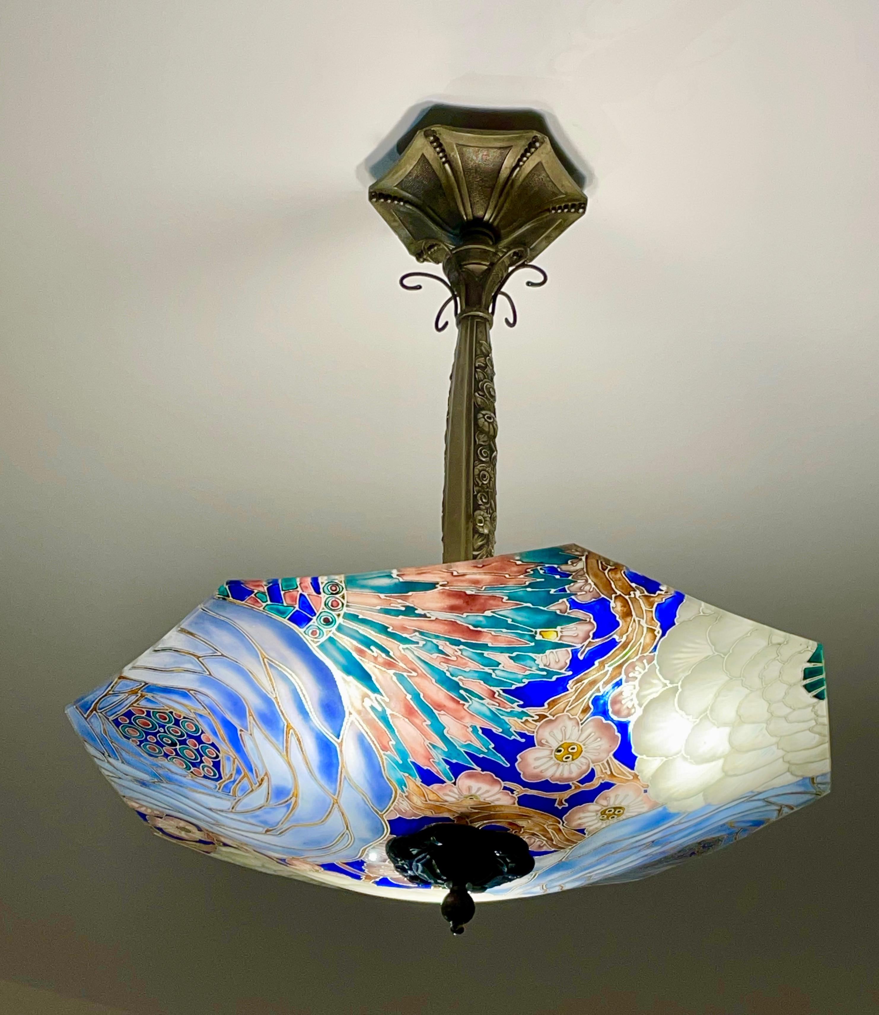French Art Deco pendant light by Loys Lucha, Paris, France, 1930s. 
This stunningly beautiful glass shade is suspended from the ceiling by a decorative bronze fitting.
The length of the bronze suspension is decorated with flowers and leaves.
The