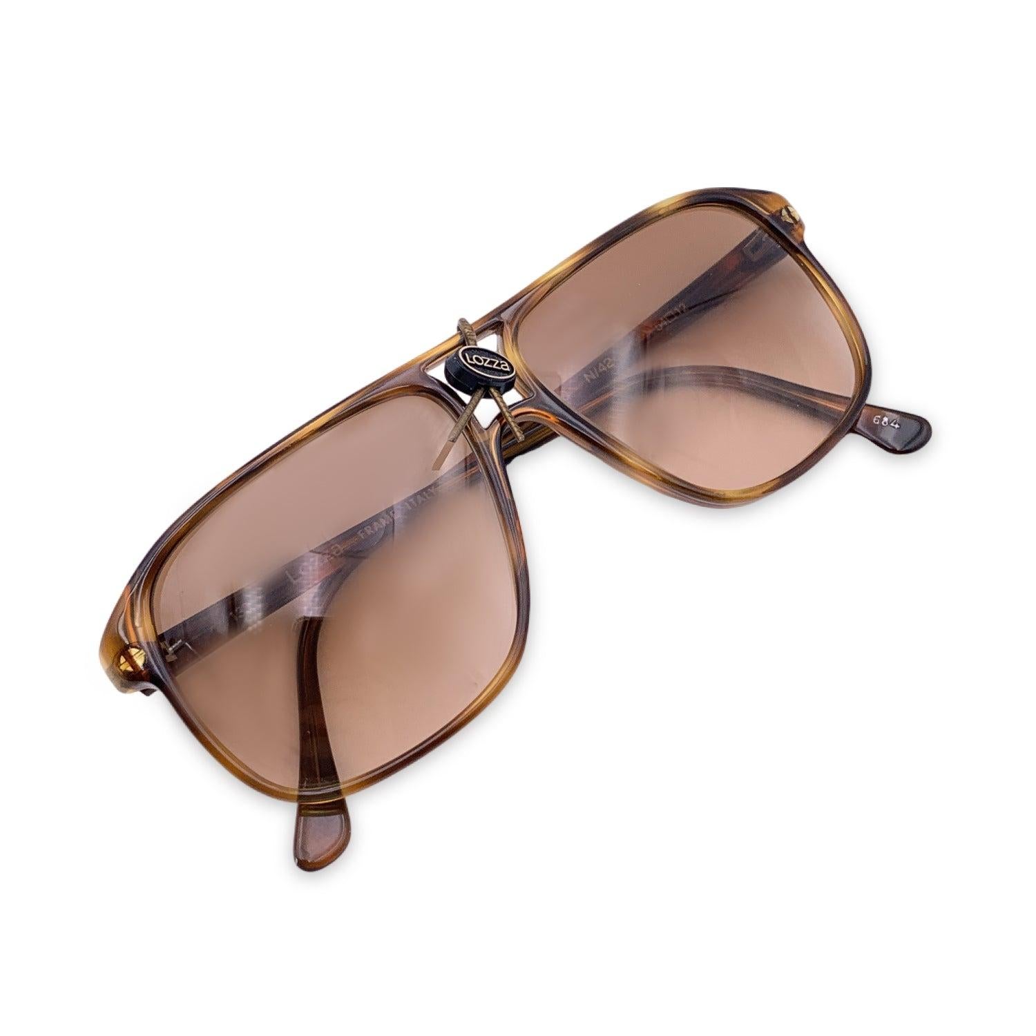 Vintage Lozza Unisex Brown Sunglasses Zilo N/42 54/12 135mm. Brown acetate aviator squared frame. 100% Total UVA/UVB protection. Brown gradient lenses. Made in Italy. Condition A+ - MINT Never Worn, do defect or wear. Details MATERIAL: Plastic