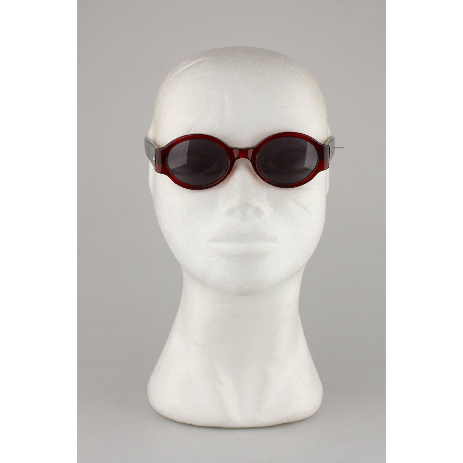 MATERIAL: Acetate COLOR: Burgundy MODEL: Round GENDER: Women SIZE: Medium COUNTRY OF MANUFACTURE: Italy Condition CONDITION DETAILS: NOS - New Old Vintage Stock - Mint Condition, never worn or used - They will come with a GENERIC CASE. Measurements