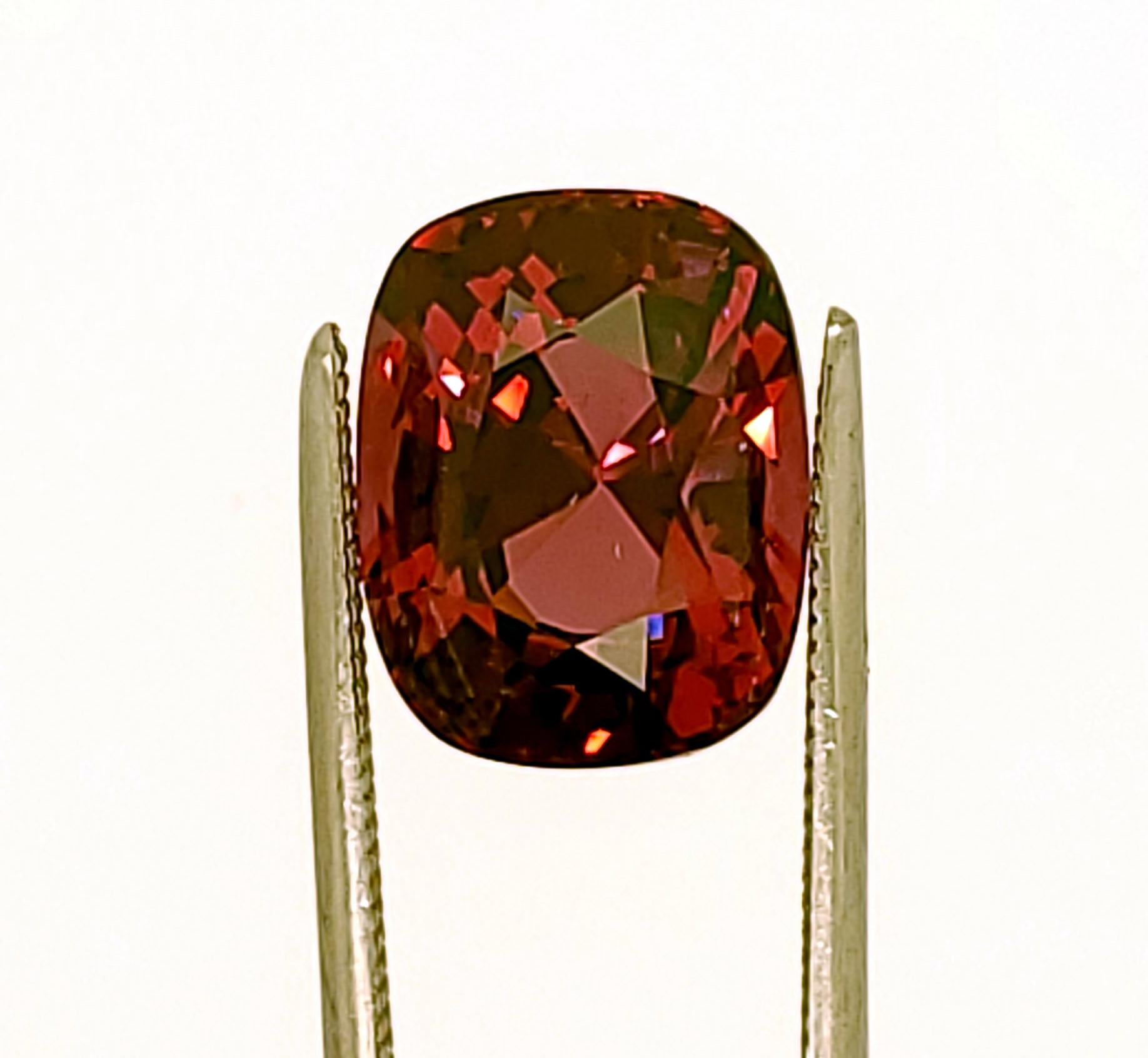 Large 4.28ct Cushion Shaped Sri Lankan (Ratnapura-Nivitigala mines) Spinel of a color that is difficult to describe, and it also color shifts (like many natural gemstones) depending on available lights and the wavelengths in those lights. Under