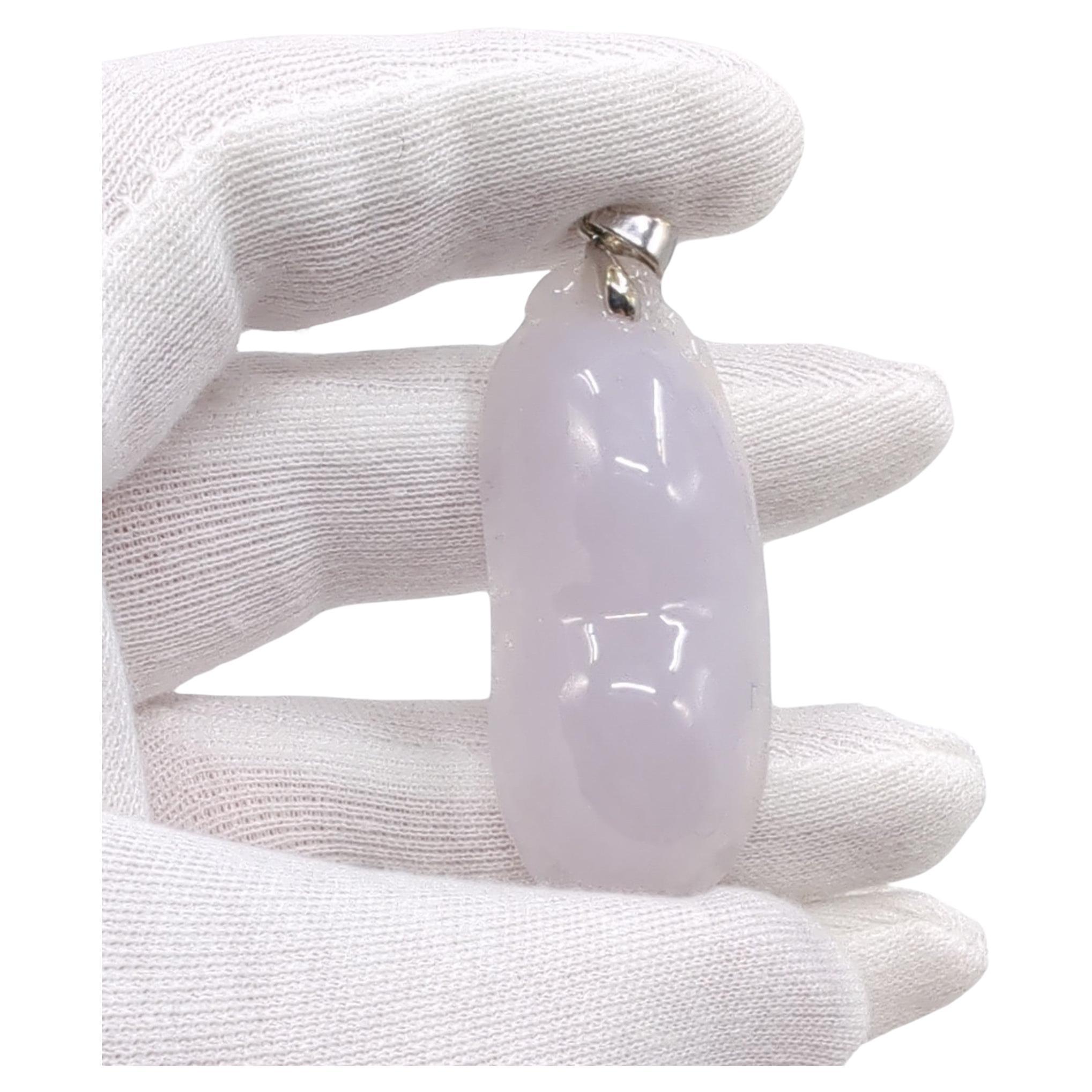 Large Chinese jadeite pendant, hand carved in the form of a pea pod. The highly translucent, polished icy jadeite is natural and untreated, and exhibits lovely faint hues of natural light lavender color. 

The white gold bale is hallmarked 18K