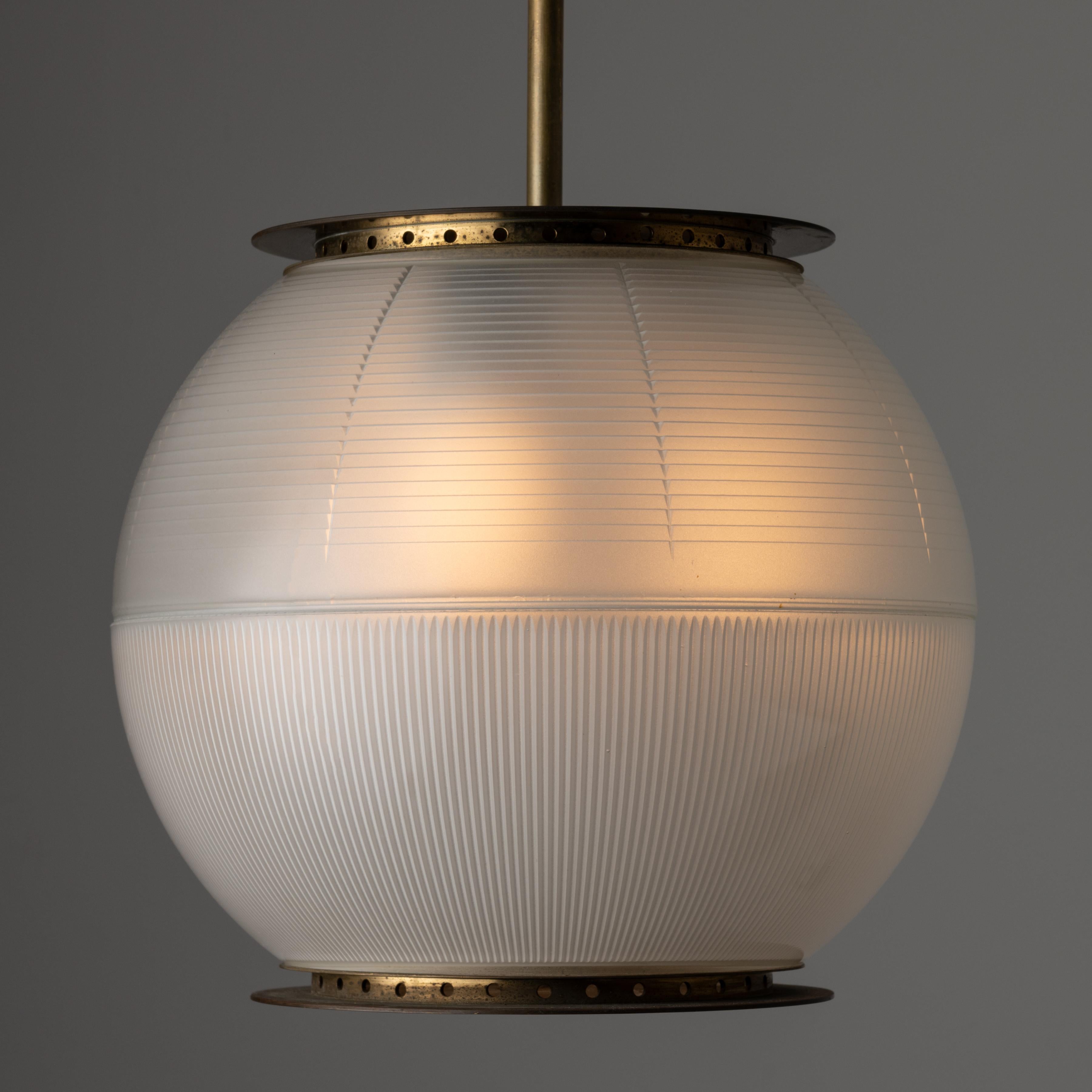 LS4 'Doppio Vetro' Ceiling Light by Ignazio Gardella for Azucena. Manufactured in Italy, in 1955. Iconic and eye-focused glass pendant comprising of a halophane double cupped diffuser, paired with an aged brass stem. The light holds a tri-socket,
