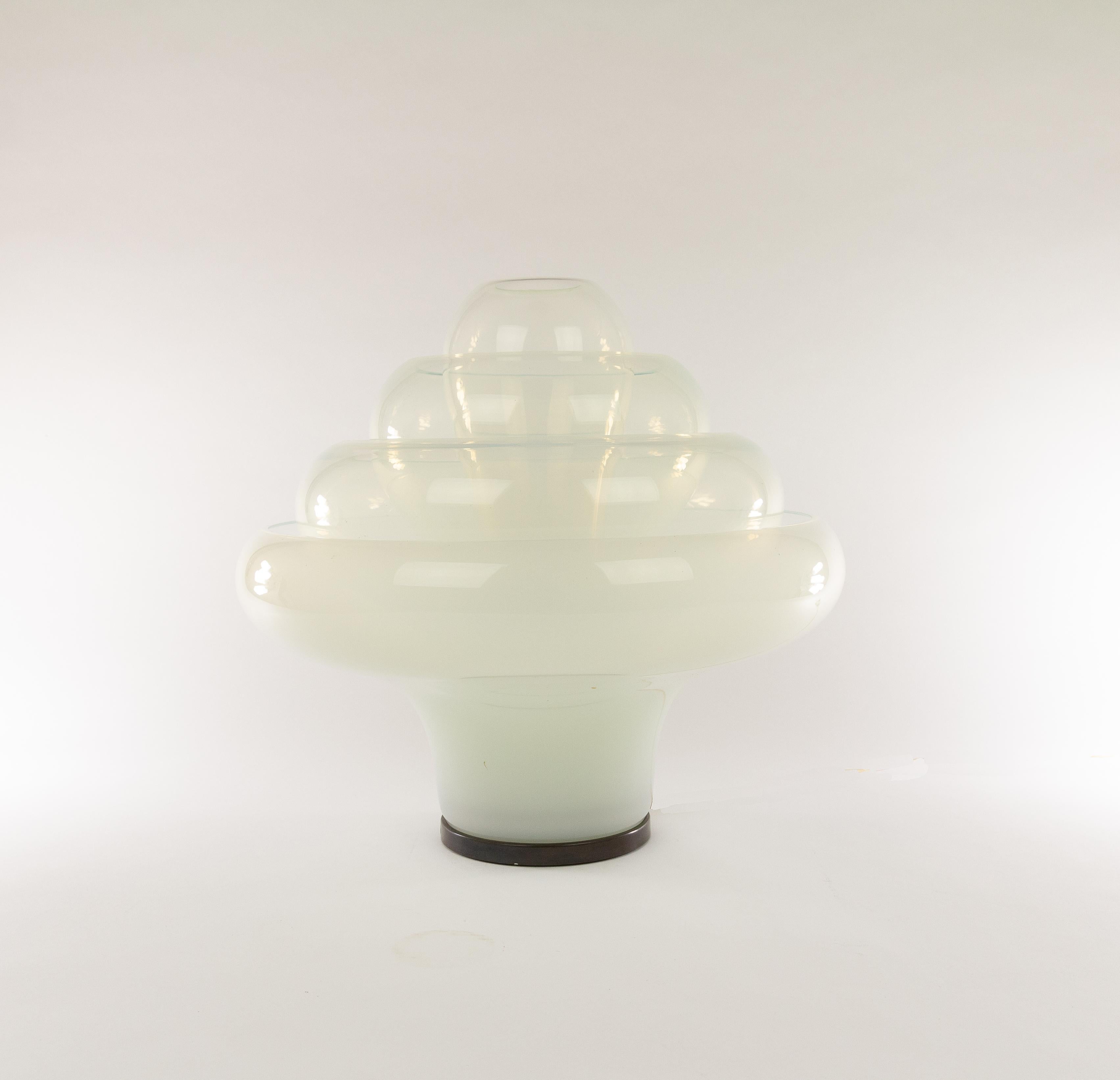Mesmerizing table lamp, model LT 305, by 'glass magician' Carlo Nason for A.V. Mazzega in the 1960s.

This ingenious object, nicknamed Lotus, consists of four interlocking individual glass shades, one central light bulb and a metal support