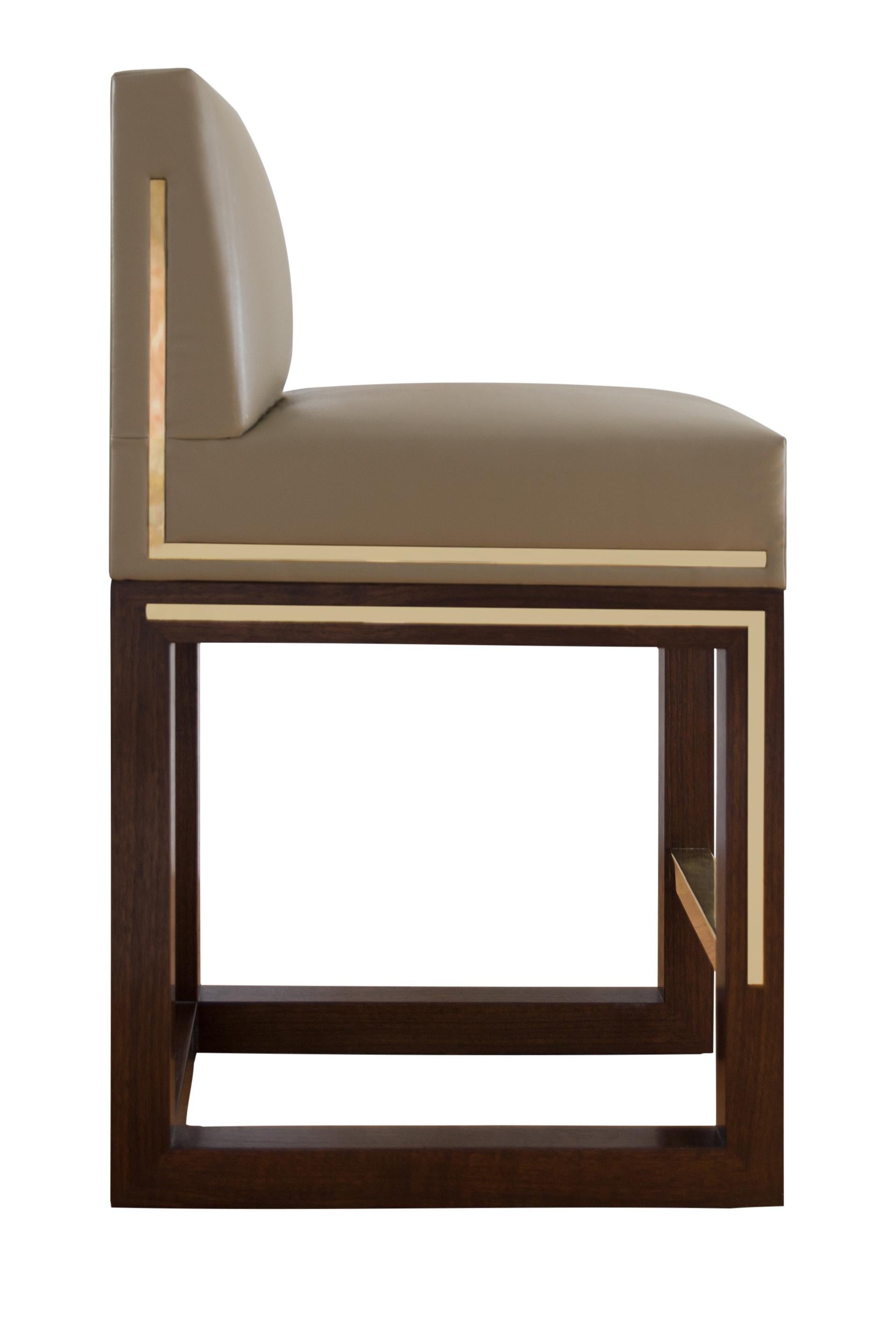 Lisa Tharp Collection  LT Signature Counter/ Bar Stool

Warm brass and cool leatherette meet rich solid walnut in this tailored, streamlined chair. Narrow width supports, yet fits comfortably even in close quarters. Polished brass inlay is a subtle