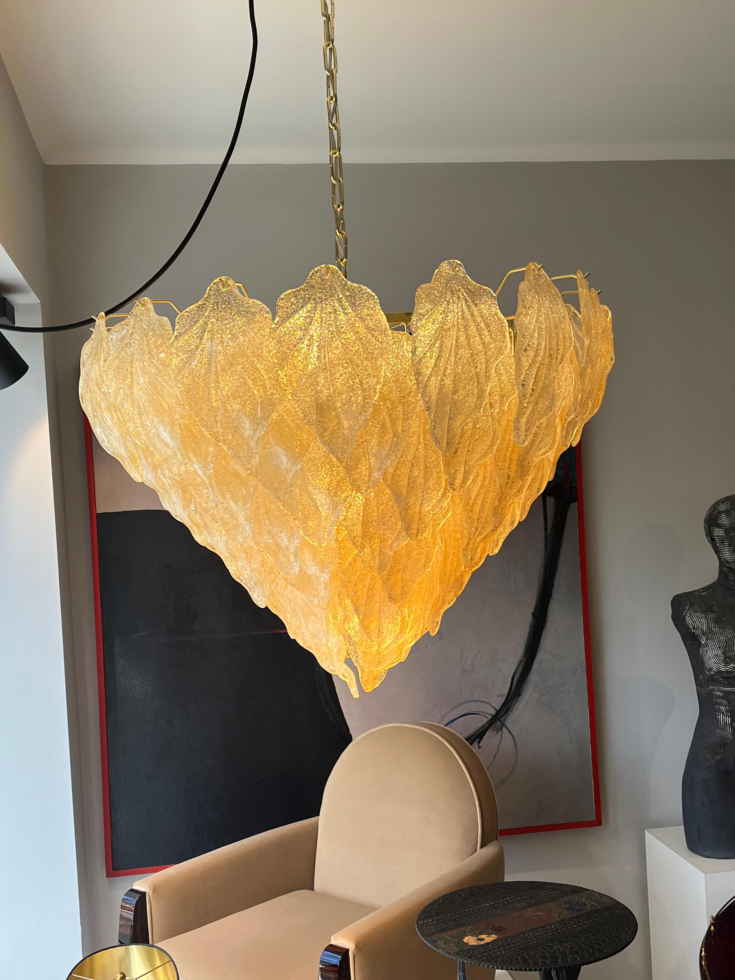 Italian late mid-century Murano glass chandelier with honey-gold leaves, Murano 1990s

The object is magnificent and restrained at the same time.
Conical in shape towards the bottom, narrowly tapering leaf ends meet.
8 rows of leaves built on top of