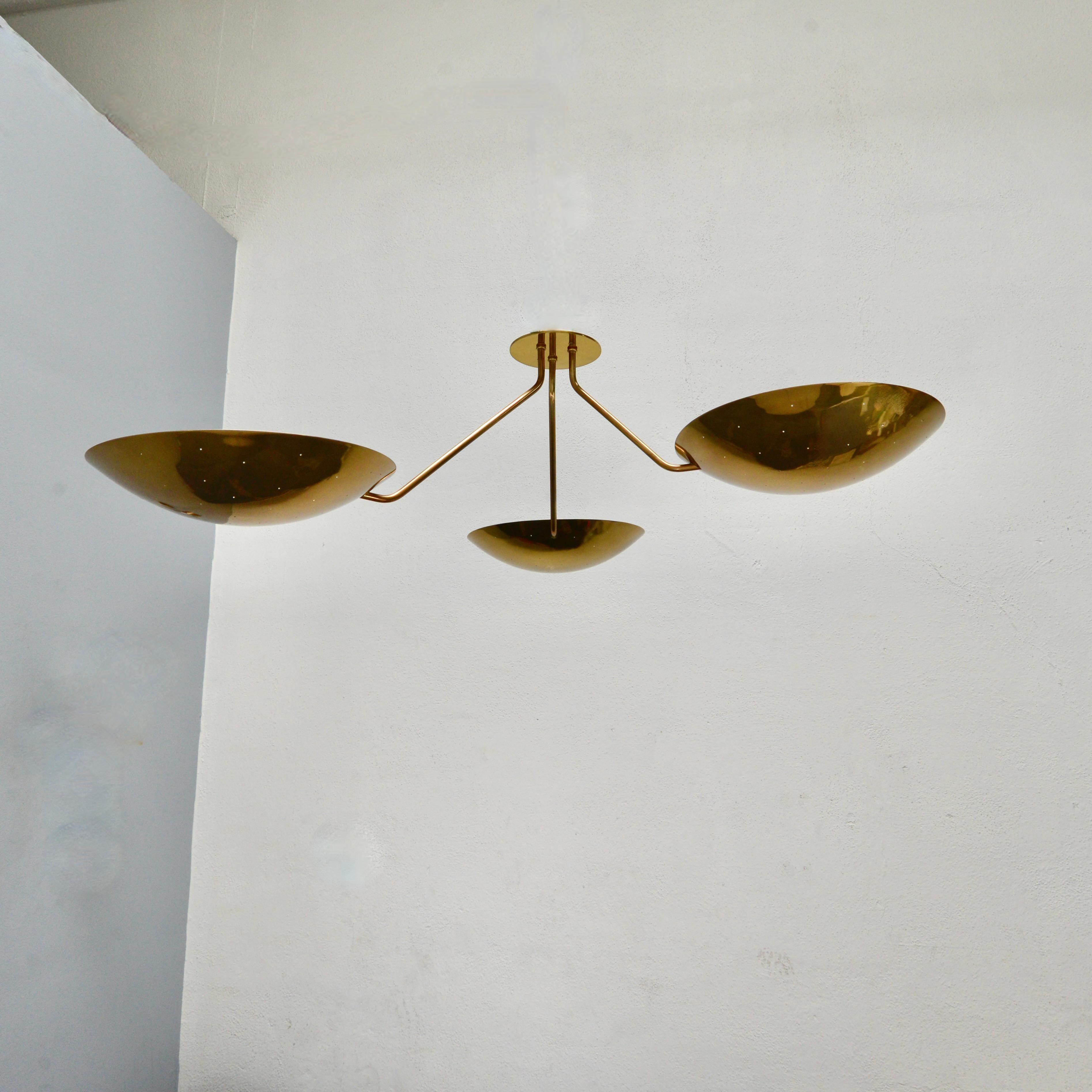 LU 3 Ceiling Fixture is an all perforated brass ceiling fixture inspired by classical mid century Italian design. This stunning fixture has 3 beautifully fabricated perforated brass dish lights joined at a center rod. Made in solid lightly aged