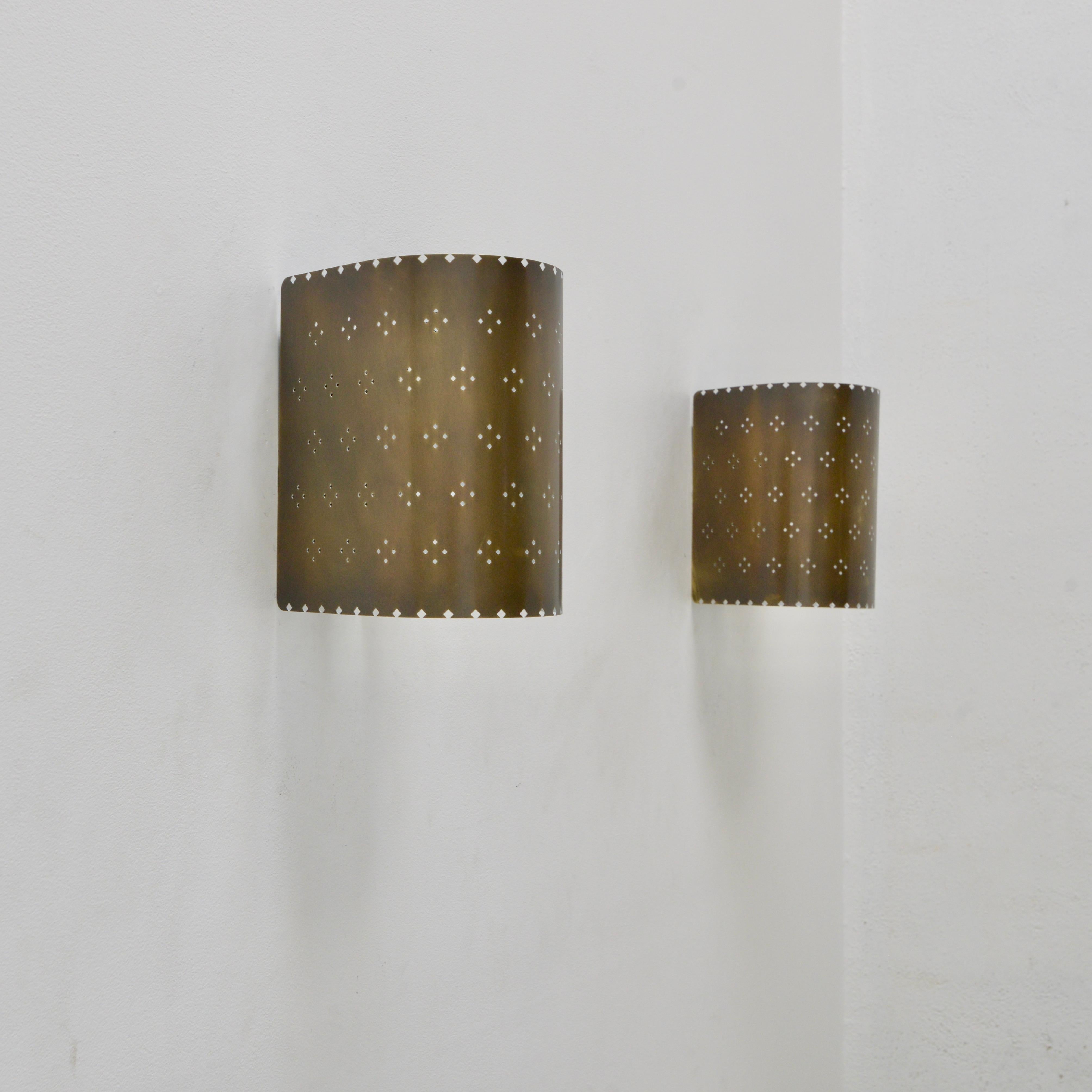 Handsome LU Louis sconce. An all brass wall sconce in patinated brass with patterned perforations by Lumfardo Luminaires. Made contemporary in the US. Multiples available for order. Can be wired for use anywhere in the world. (2) E26 medium based