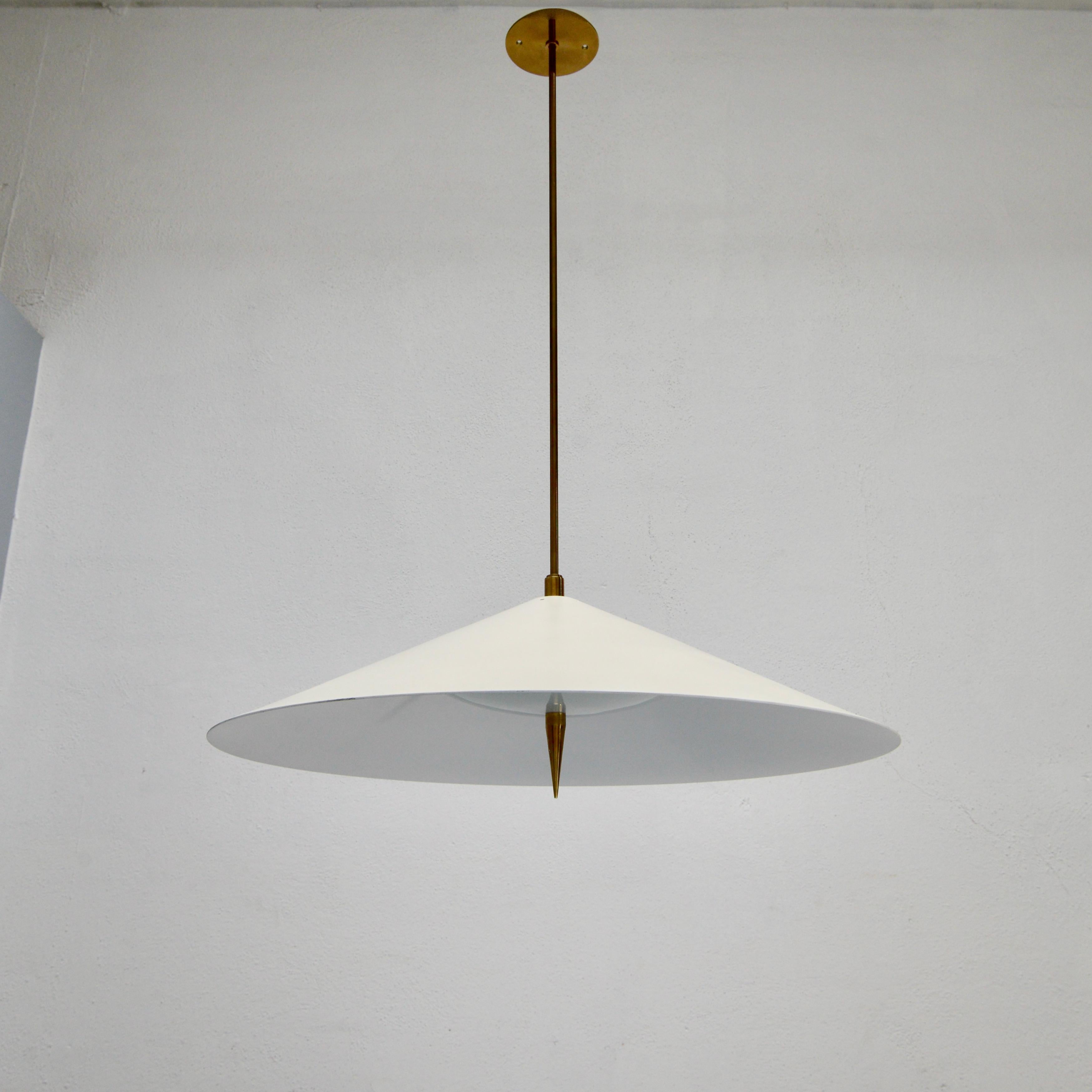 Part of Lumfardo Luminaries contemporary collection, the LUsaucer pendant fixture is a classic Italian mid century modern design made to order. Crafted from patinated brass, painted aluminum and glass. This fixture can be wired for any worldwide
