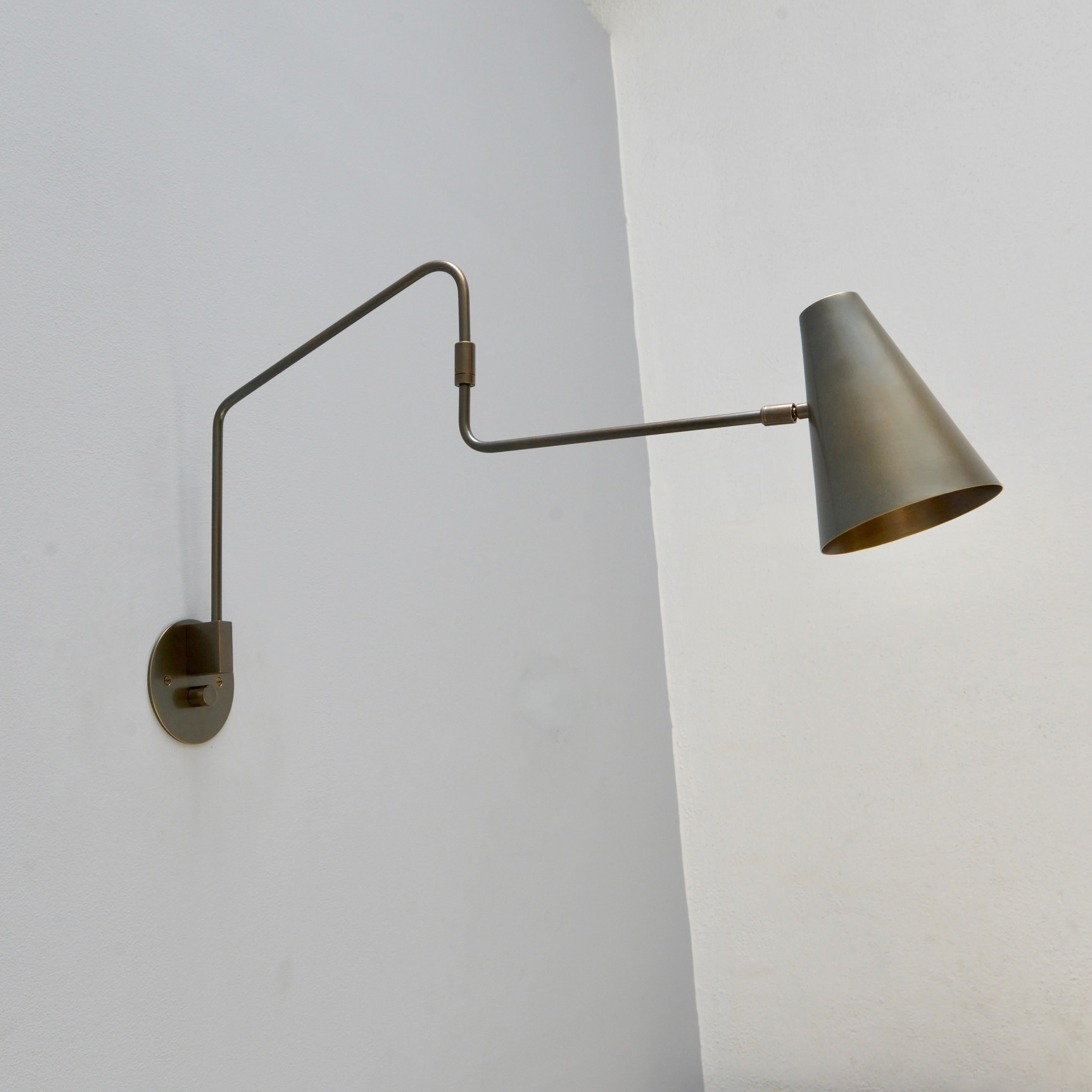 Beautiful patinated brass LU Swing Sconce by Lumfardo Luminaires. Made contemporary in the US. Fabricated in all brass in a rich dark patinated finish. Multiples available for order. Wired with E26 medium based socket, but can also be wired for use