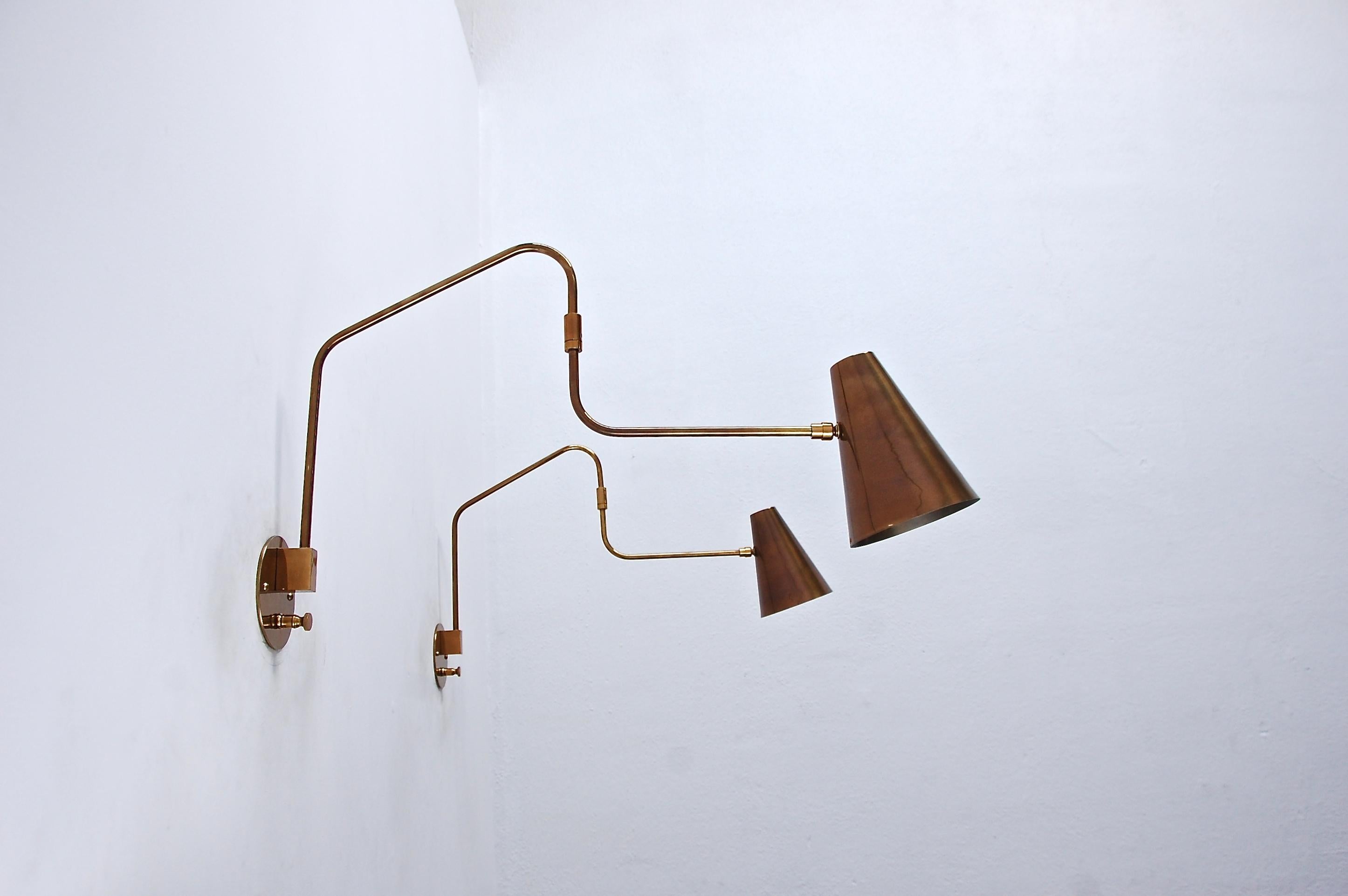 Beautiful brass LU swing sconce made by Lumfardo Luminaires in patinated brass. Wired with an E26 medium based socket. Light bulb provided as well as all mounting hardware. Priced individually.

Measurements: 
Height 15”
Depth/length: 25.25”,