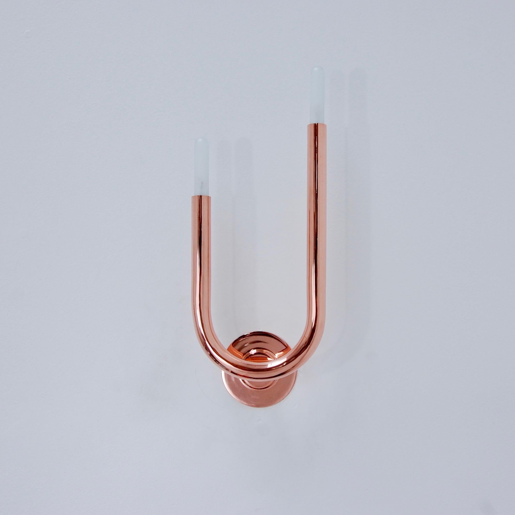 Superb and sleek modern LU wall sconces by Lumfardo Luminaires in polished un-lacquered copper. (2) candelabra E12 based sockets per sconce, 15 watts incandescent light bulb per socket. Light bulbs included with order. Priced as a