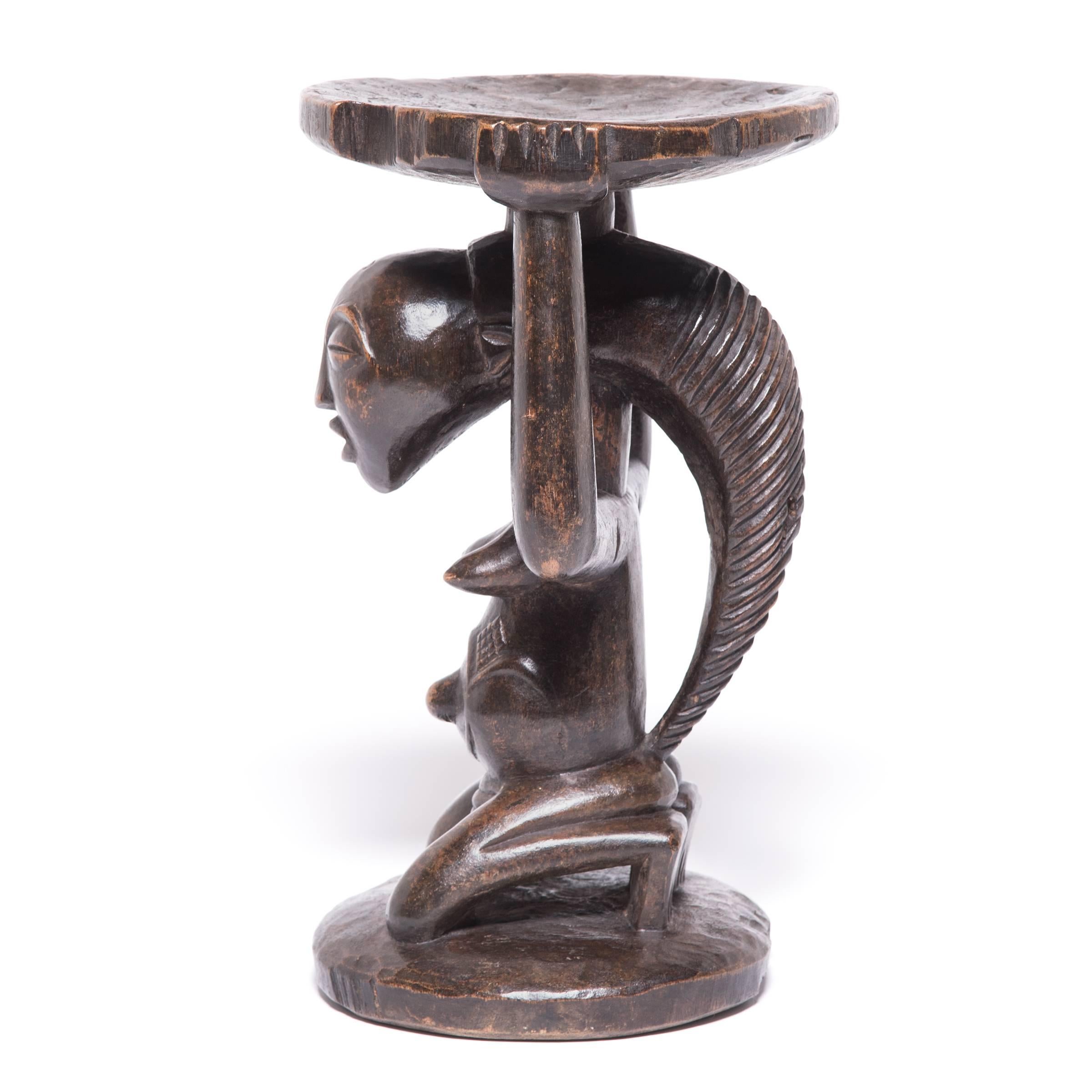 This stool by the Luba people of Zaire beautifully illustrates their storied craft. A single tree trunk was carved down to a column, then carefully taken in further until the form of a kneeling woman with intricately braided hair appeared. She