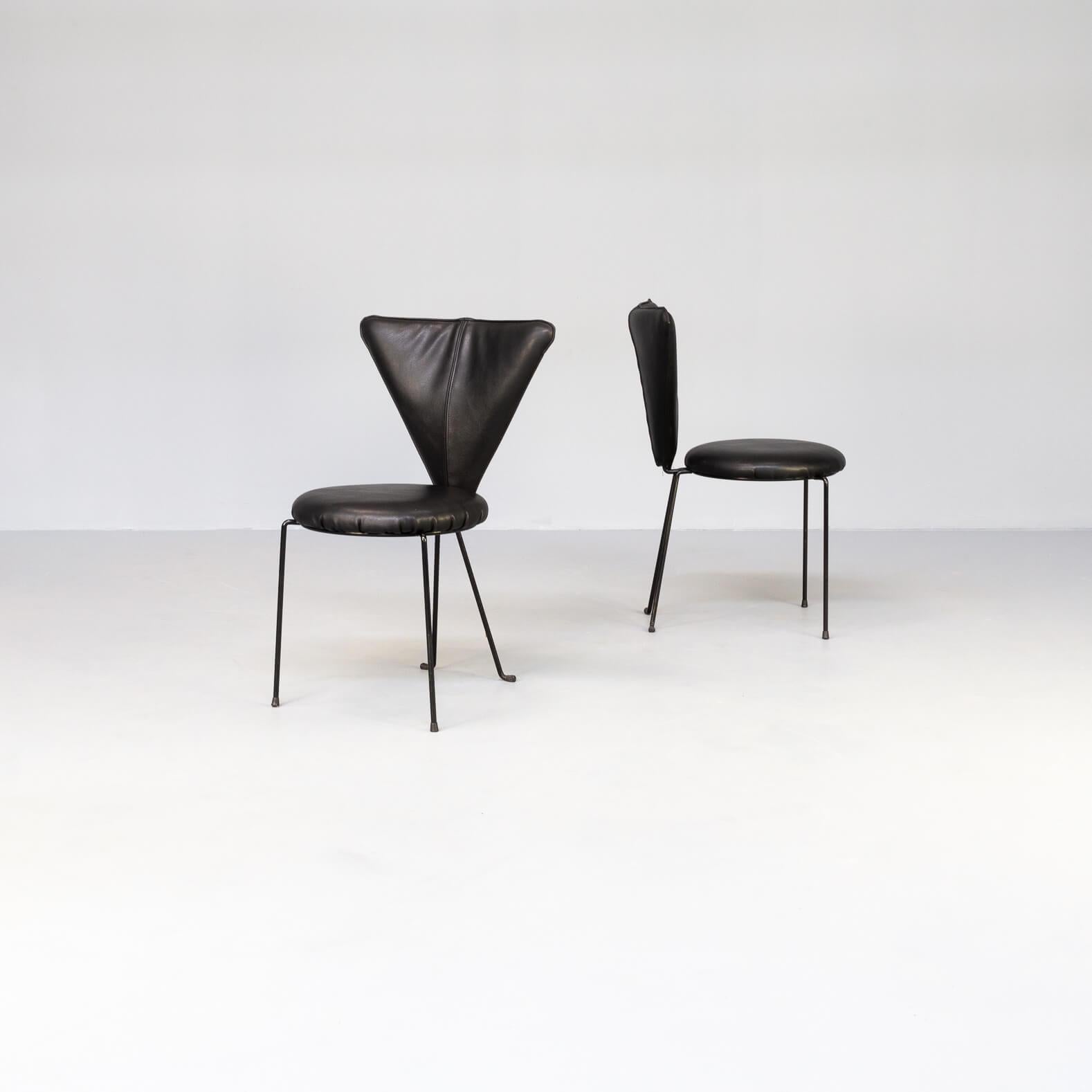 A rare set of two black leather dining chairs with painted black steel legs. Made in Germany, circa 1980s. Designed by Helmut Lubke & Co. The beauty of these chairs are in the usage of different forms like triangle and round curves. Even use of