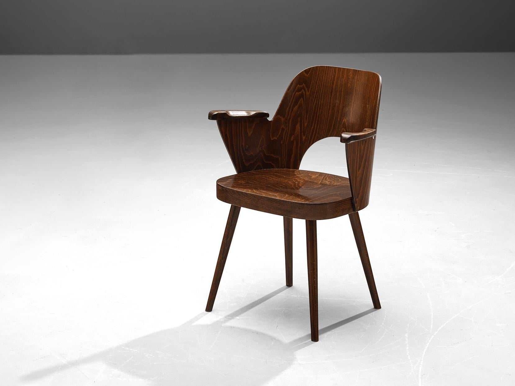 Lubomír Hofmann for TON, armchair, stained beech, Czech Republic, 1950s

This bended plywood armchair is designed by Lubomír Hofmann for the bentwood manufacturer TON. This design shows nice curves and elegant lines. While the dark brown stained