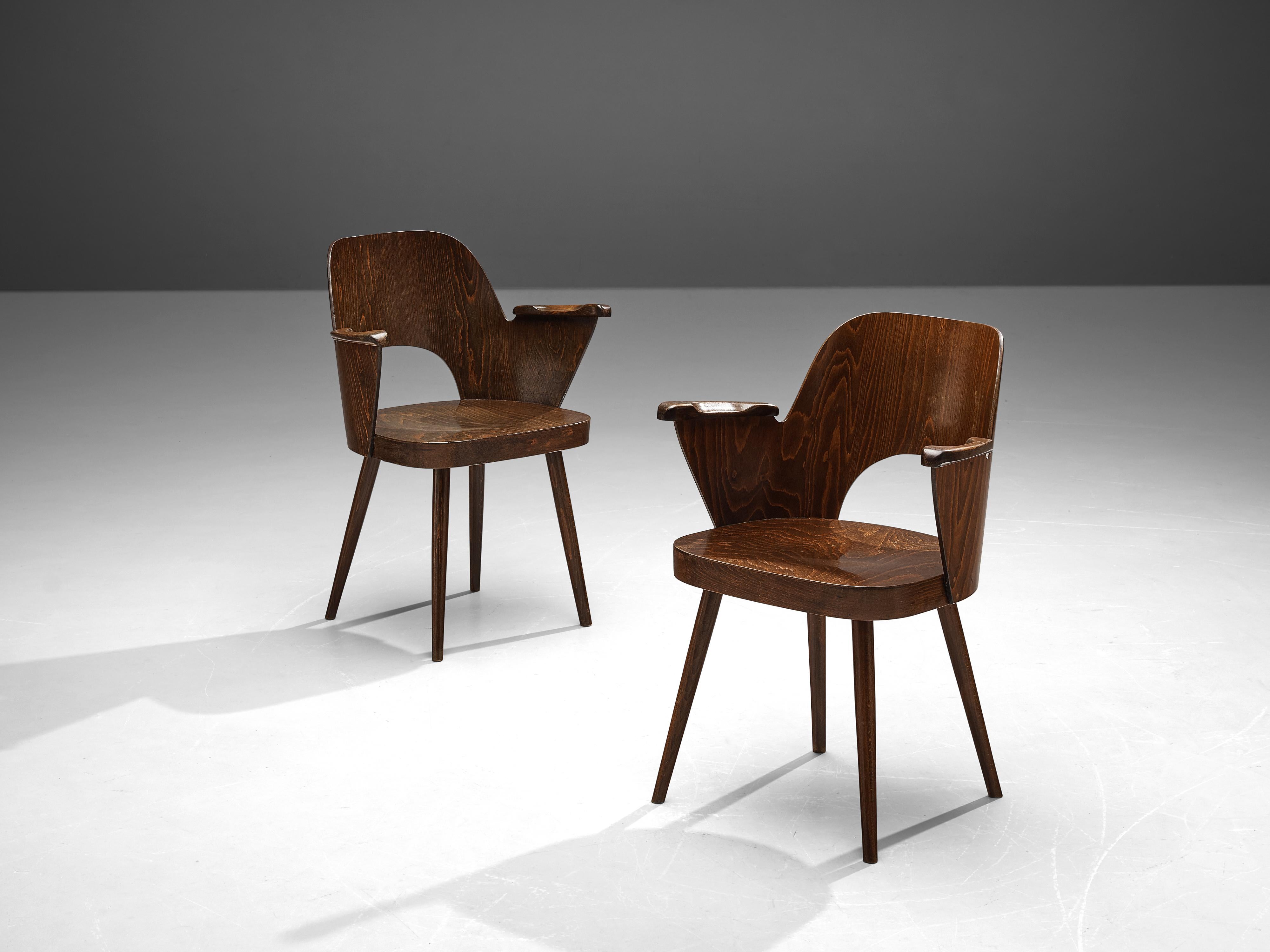 Lubomír Hofmann for TON, armchairs, wood, Czech Republic, 1950s

Pair of bended plywood armchairs. These chairs were designed by Lubomír Hofmann for the bentwood manufacturer TON. These chairs show nice curves and elegant lines. While the dark