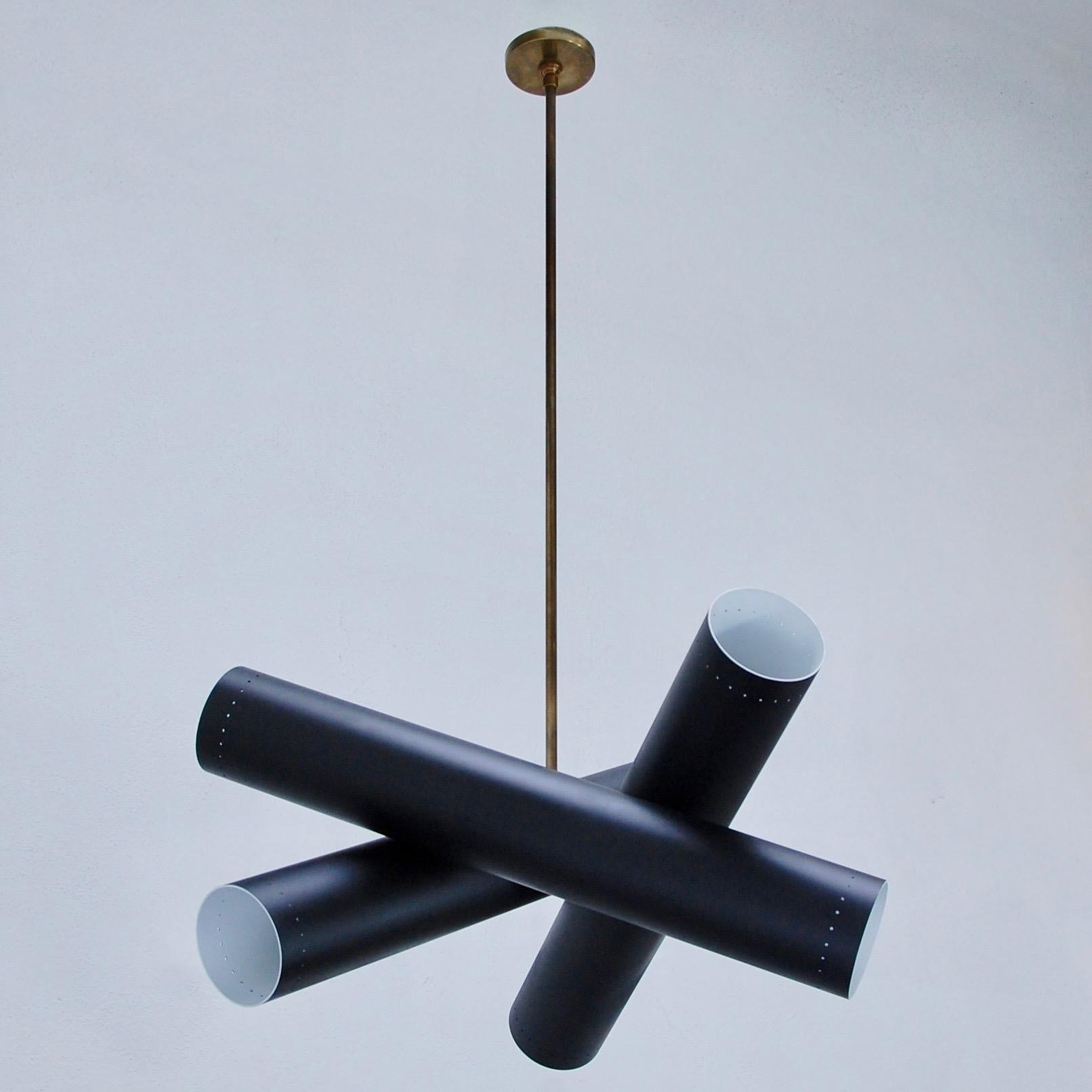 Modern, geometric Lubular pendant by Lumfardo Luminaires. Three cylindrical tubular shades criss crossing to create directional light. Made to order. Brass and painted aluminium finish. Custom finish and OAD can be made upon request. Two E26 medium