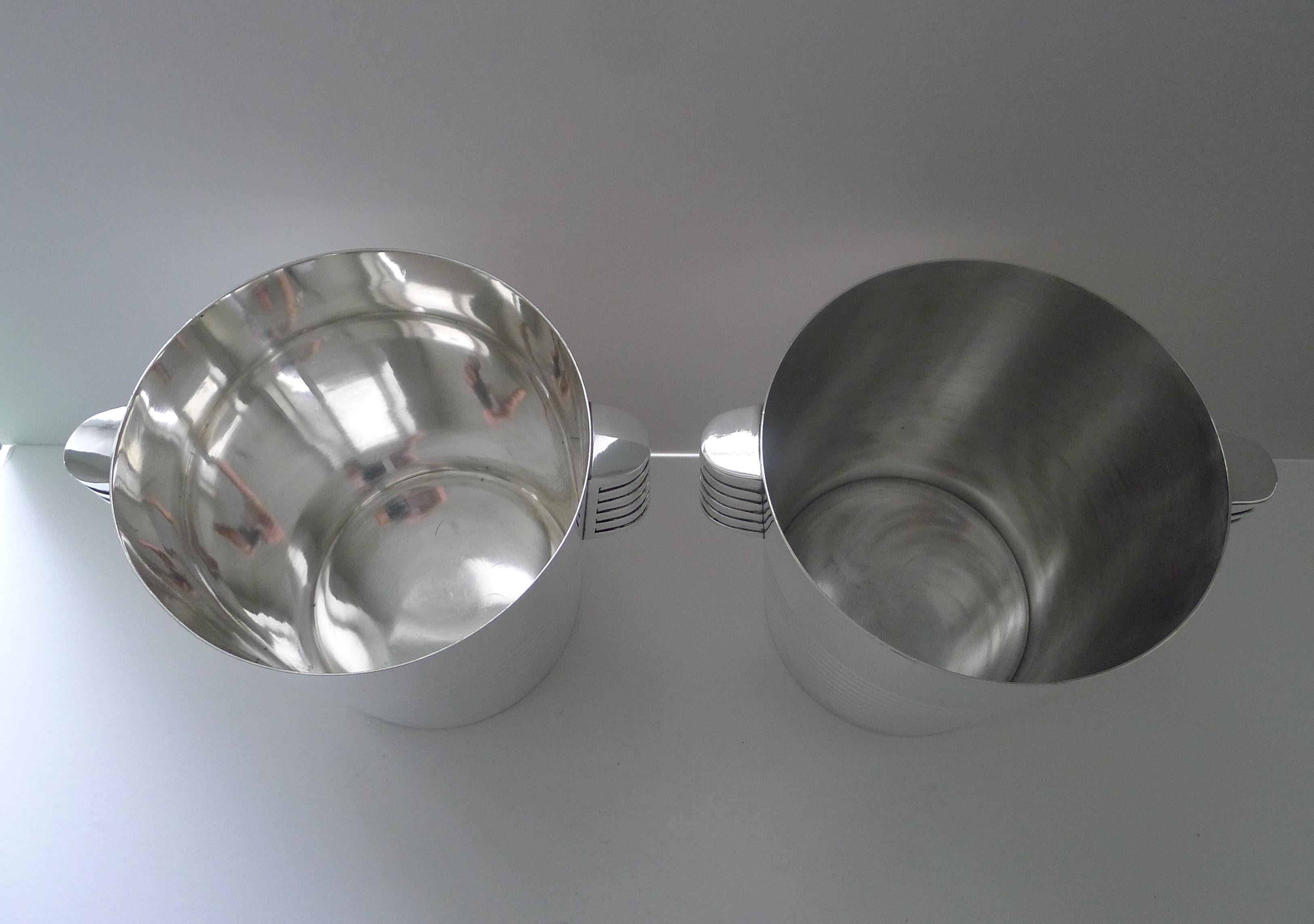 A rare opportunity to secure a pair of Art Deco silver plated Champagne buckets designed by the celebrated Luc Lanel for Christofle designed in1932.  A stylish ribbed vessel with with ribbed lug handles;

The pattern , called “Ondulations” was