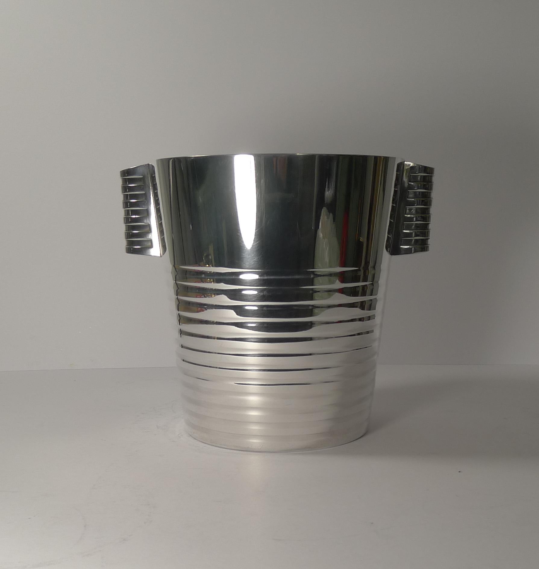 A fabulous Art Deco silver plated champagne bucket designed by the celebrated Luc Lanel for Christofle designed in1932. A stylish ribbed vessel with ribbed lug handles;

The pattern, called “Ondulations” was originally designed for the First Class