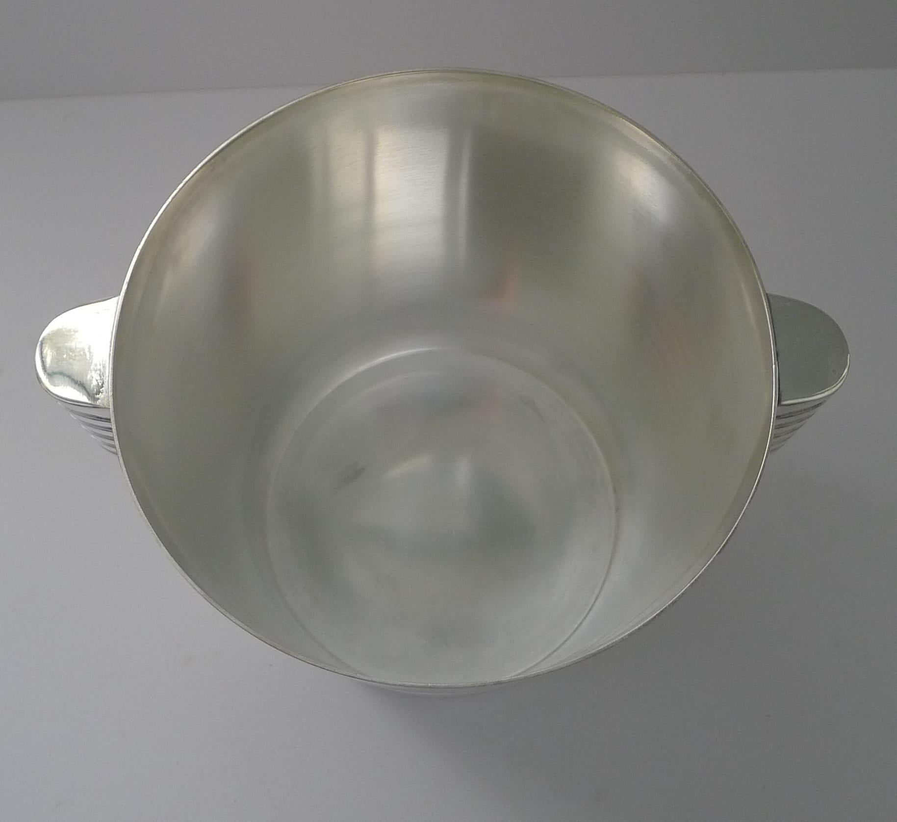 A fabulous Art Deco silver plated Champagne bucket designed by the celebrated Luc Lanel for Christofle designed in1932.  A stylish ribbed vessel with with ribbed lug handles;

The pattern , called “Ondulations” was originally designed for the  First
