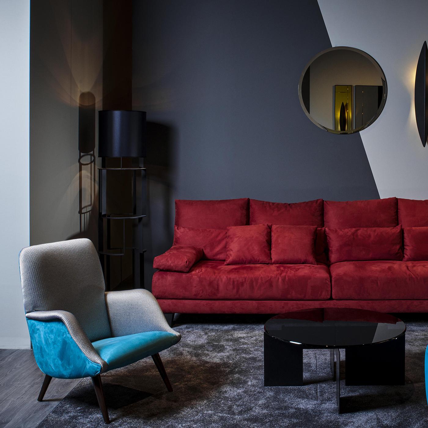 The arms and back of this sleek, cozy armchair are covered in herringbone fabric which stands in contrast to its bright turquoise seat, for an effect that is classic, bold and modern. Its wooden legs have a dark walnut finish. The Chelini Firenze