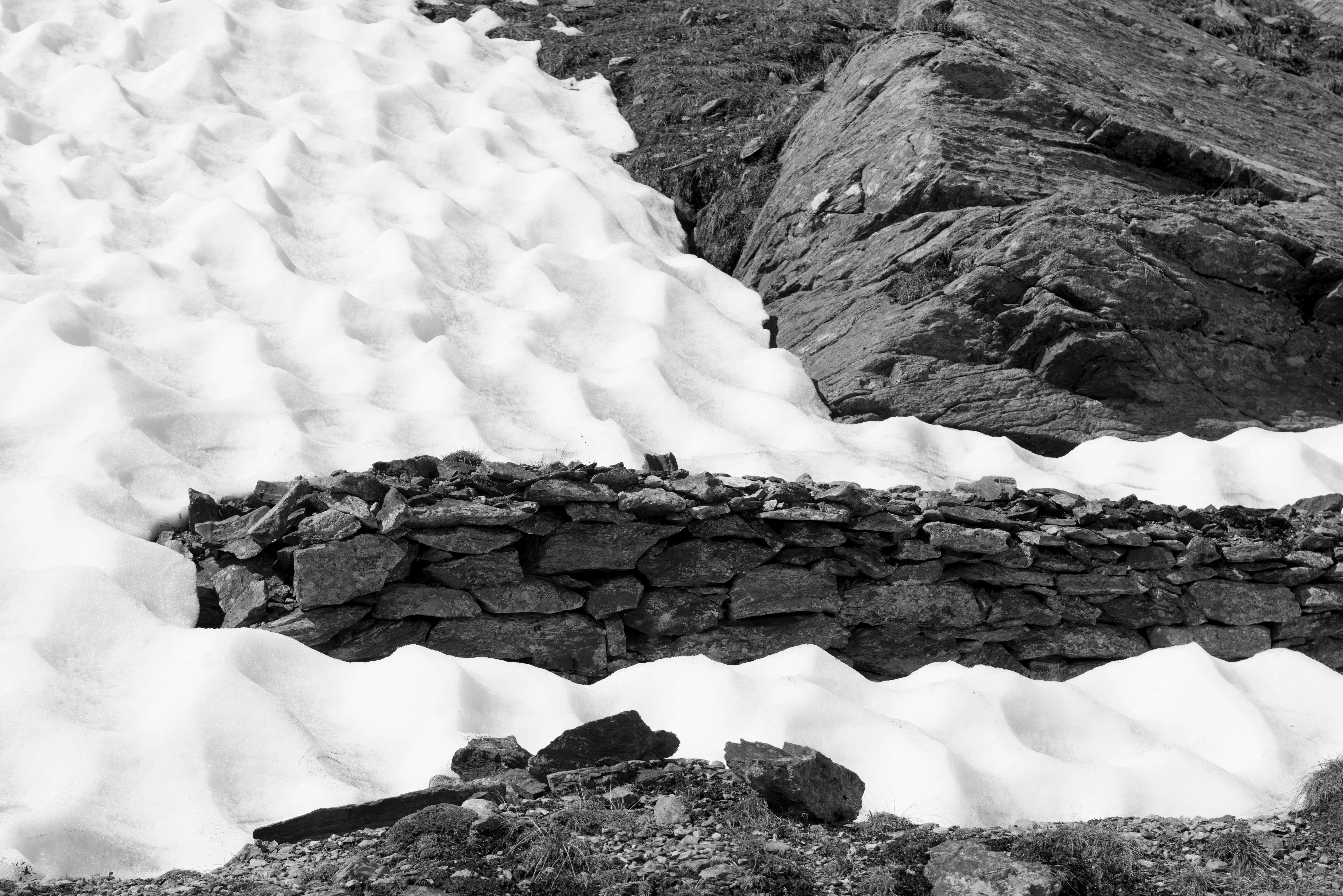A Fatal Pass, War remains emerging from the snow. Black and White landscape - Photograph by Luca Artioli