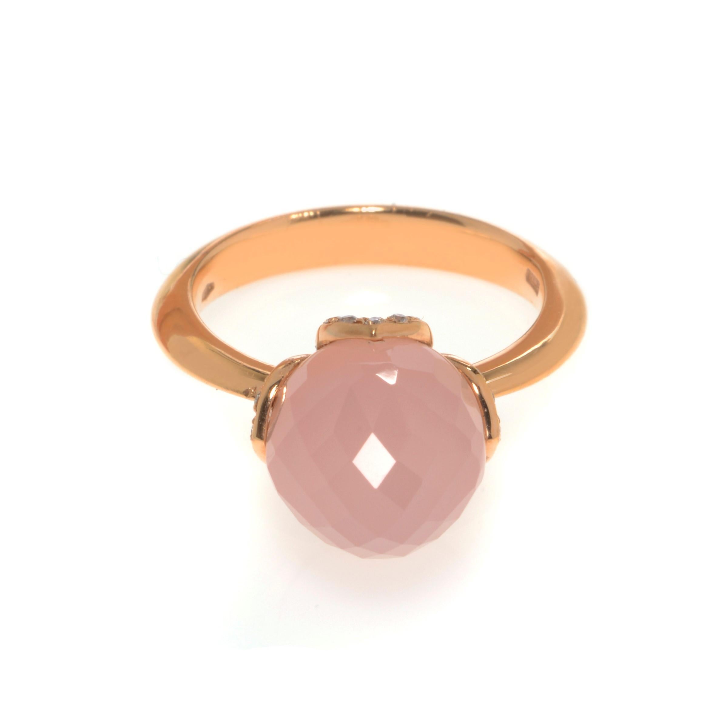 Beautiful and unique this ring features a large single natural pink Chalcedony gemstone set in a romantic rose gold setting. Set with tiny 0.13cttw of white diamonds. Diamond color G and VVS clarity. Chalcedony weight: 1.80 grams. Ring size 7. Comes