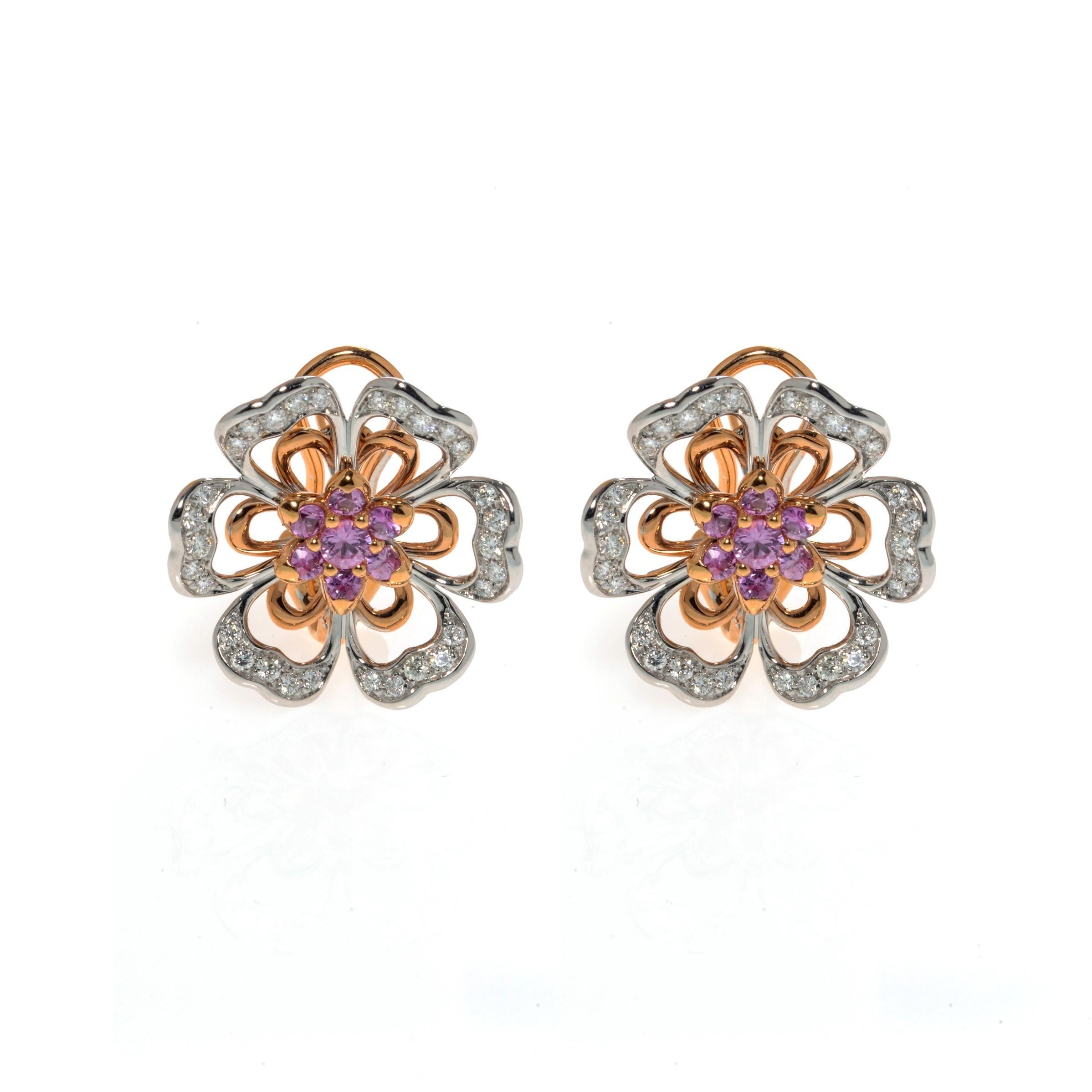 This gorgeous pair of estate earrings is finely crafted in solid 18K rose and white gold, made in the shape of beautiful flowers. Set with pink natural Sapphires and brilliant cut diamonds. The total diamond weight for the pair is 0.70 carats of
