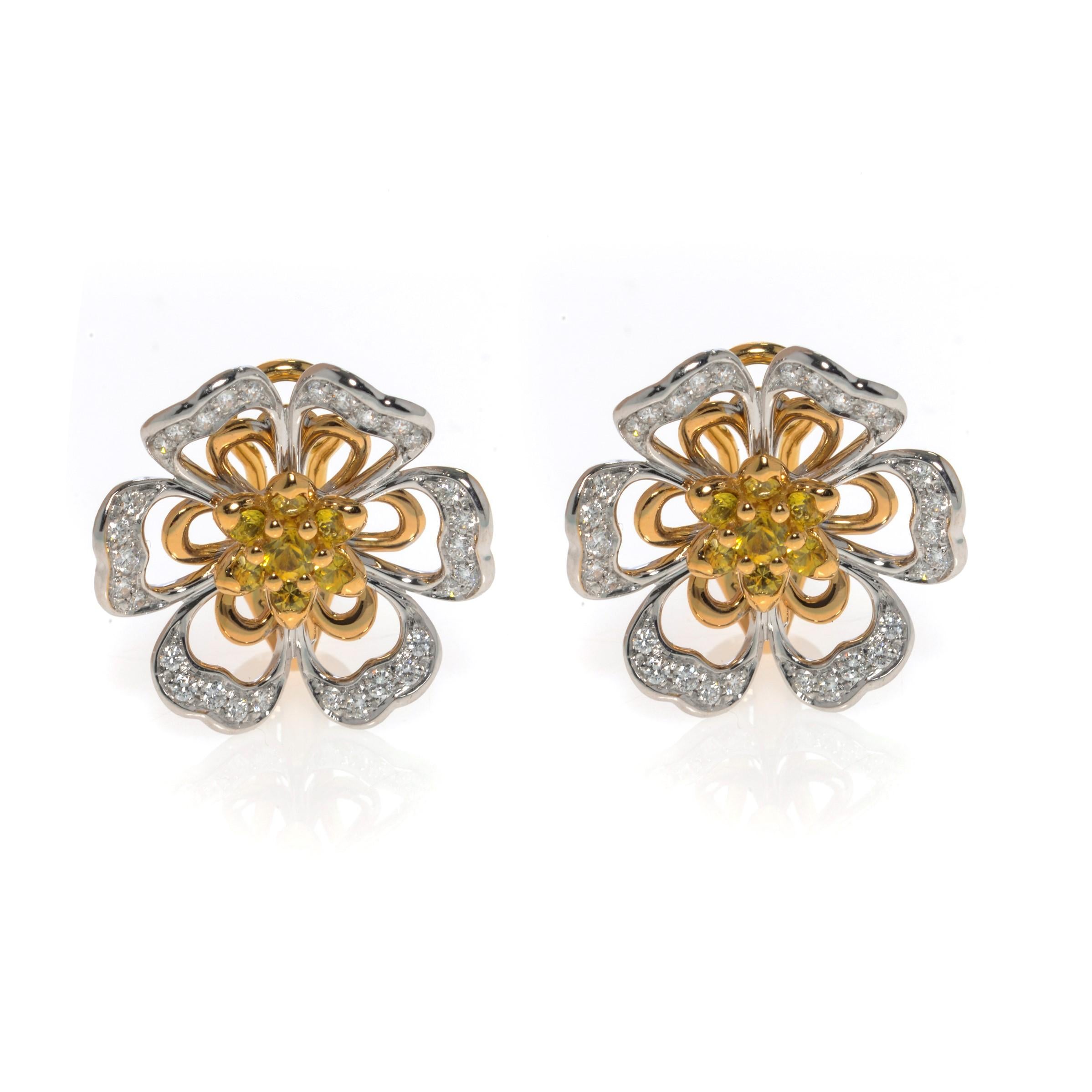 This gorgeous pair of estate earrings is finely crafted in solid 18K rose and white gold, made in the shape of beautiful flowers. Set with yellow natural Sapphires and brilliant cut diamonds. The total diamond weight for the pair is 0.70 carats of