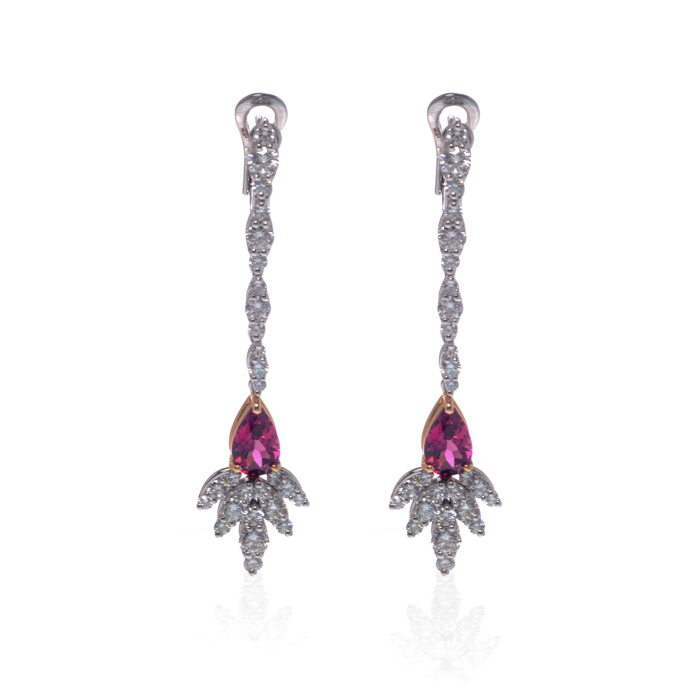 These alluring pink tourmaline and diamond drop earrings are crafted in 18k white gold. The pear-shaped pink Tourmalines are prong-set with some of glimmering round cut diamonds. Total weight of Tourmaline, 1.95cts. Total diamond weigh: 2.72cts.