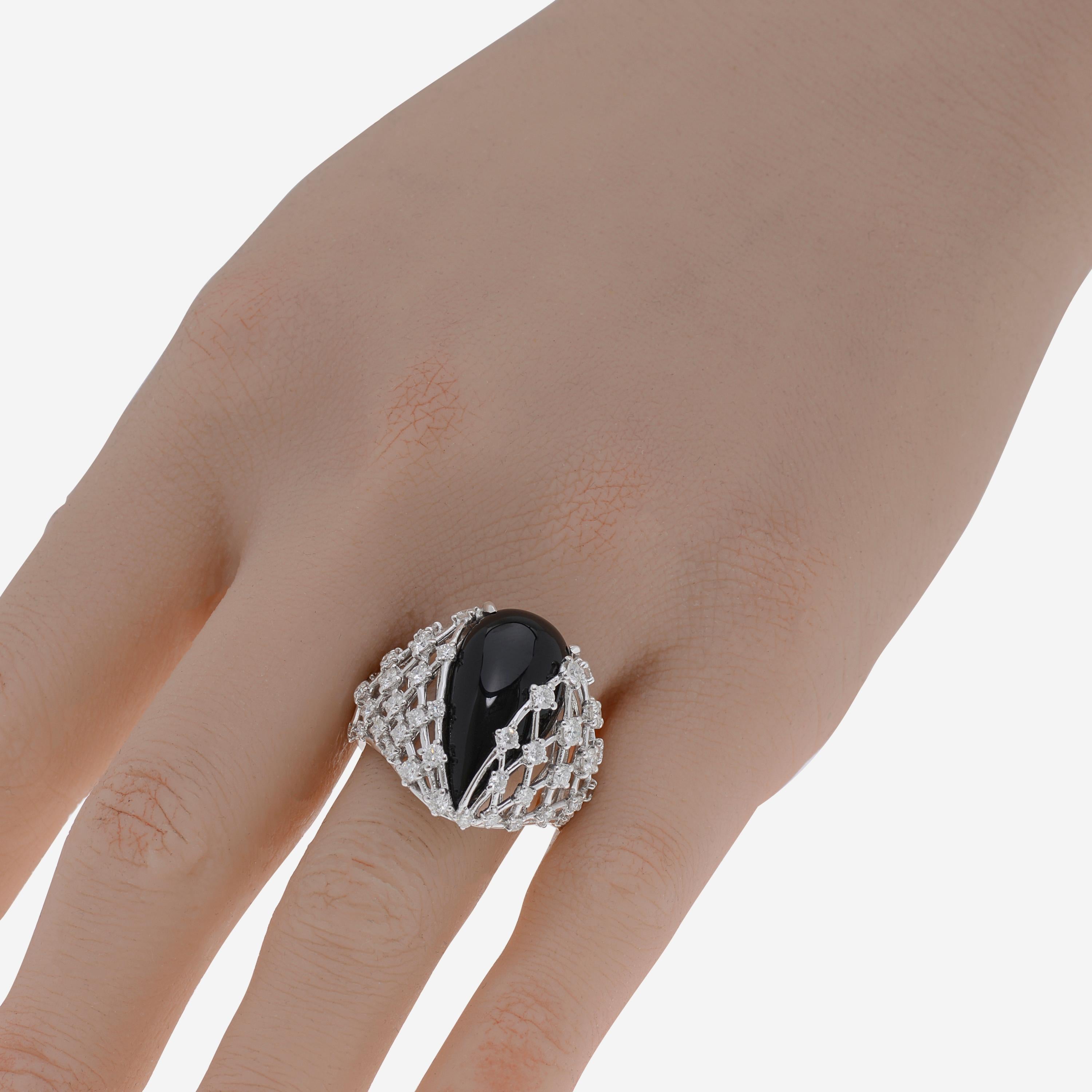 This adventurous Luca Carati 18K White Gold Cocktail Ring features shimmering 1.26ct. tw. prong set accent diamonds adorning an Onyx center. The ring size is 8.25 (57.7). The Band Width is 2.7mm. The Weight is 10g.
