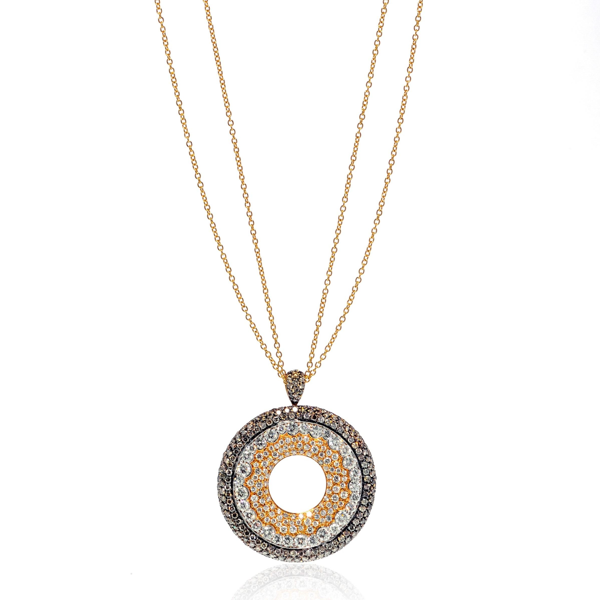 This magnificent diamond pendant with lavish white and brown diamonds create a look that will make you feel truly luxurious and elegant. Presented in fine 18k yellow gold with a black rhodium. Showcasing a set of 3.91cttw of white round cut diamonds