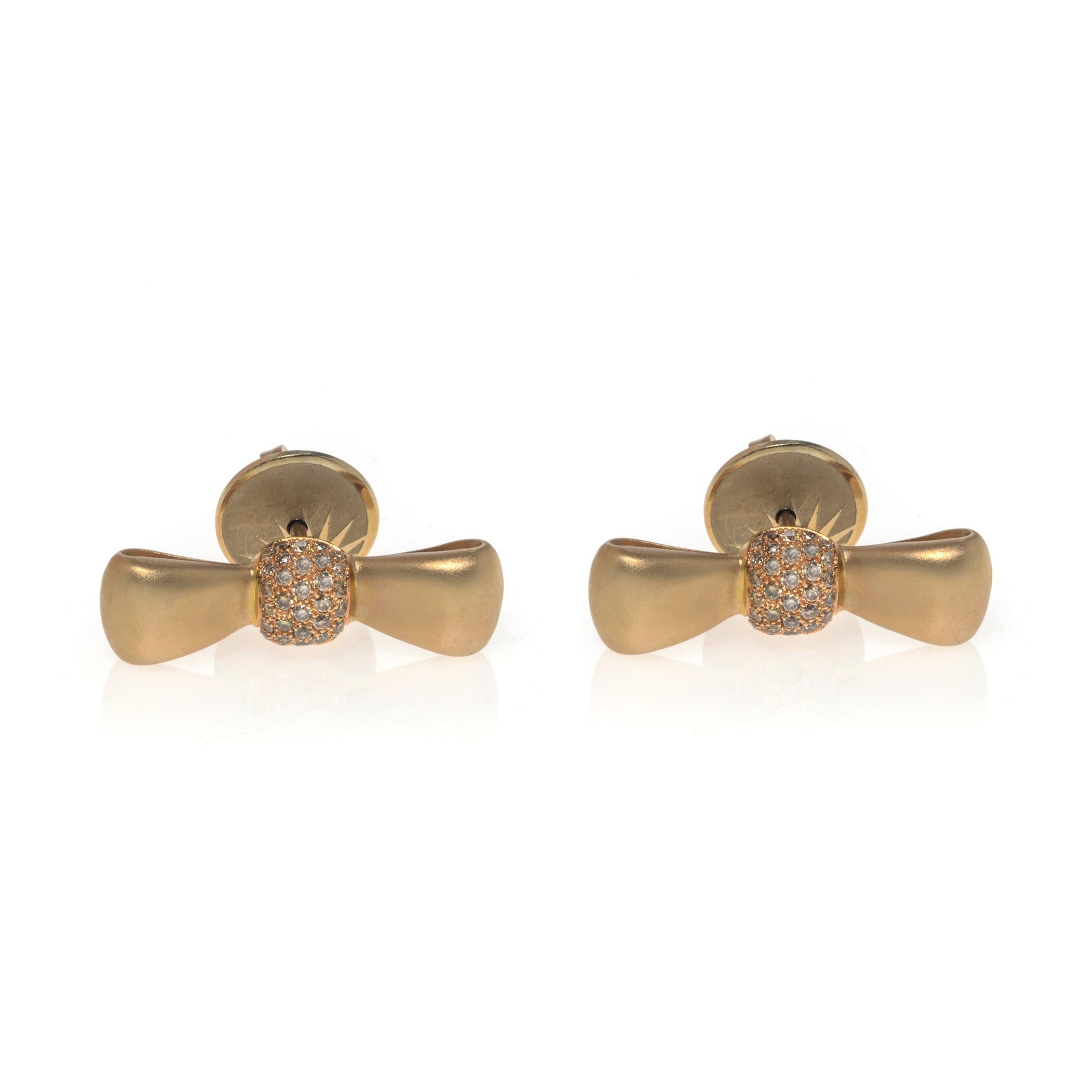 These beautiful bow stud earrings by Luca Carati are crafted in 18k yellow gold. These earrings feature pave set natural brown diamonds weighing 0.37cttw. Secured with pushback post. Earring size: 22x6mm. Comes with a box and a certificate. 