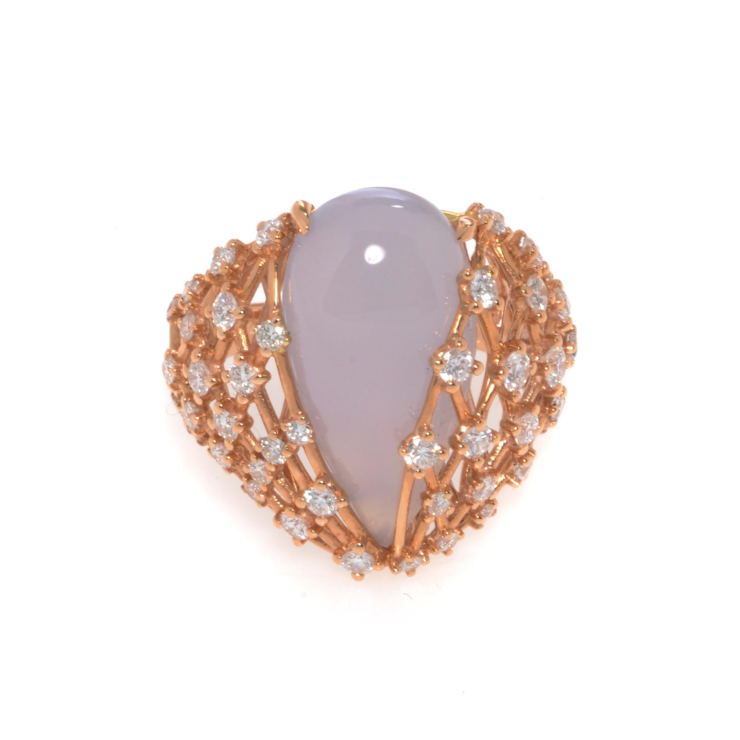 This beautiful cocktail ring features a large natural pear shape Chalcedony in 18k yellow gold setting. Set with 1.25cttw of brilliant cut diamonds. Diamond color G and VVS clarity. Chalcedony weights 1.90 grams. Ring size 7.5. Top measurements: