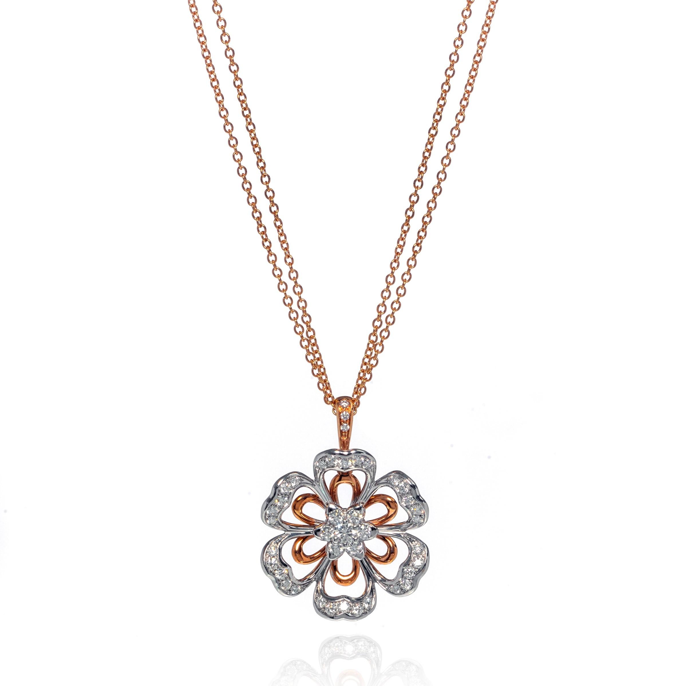 This beautiful Luca Carati 18k rose and white gold pendant necklace features a gorgeous display of diamonds 1.11cttw with a flower shaped design. An 18k white gold floral setting overlaid on an airy rose gold floral setting with a beautiful 18k rose
