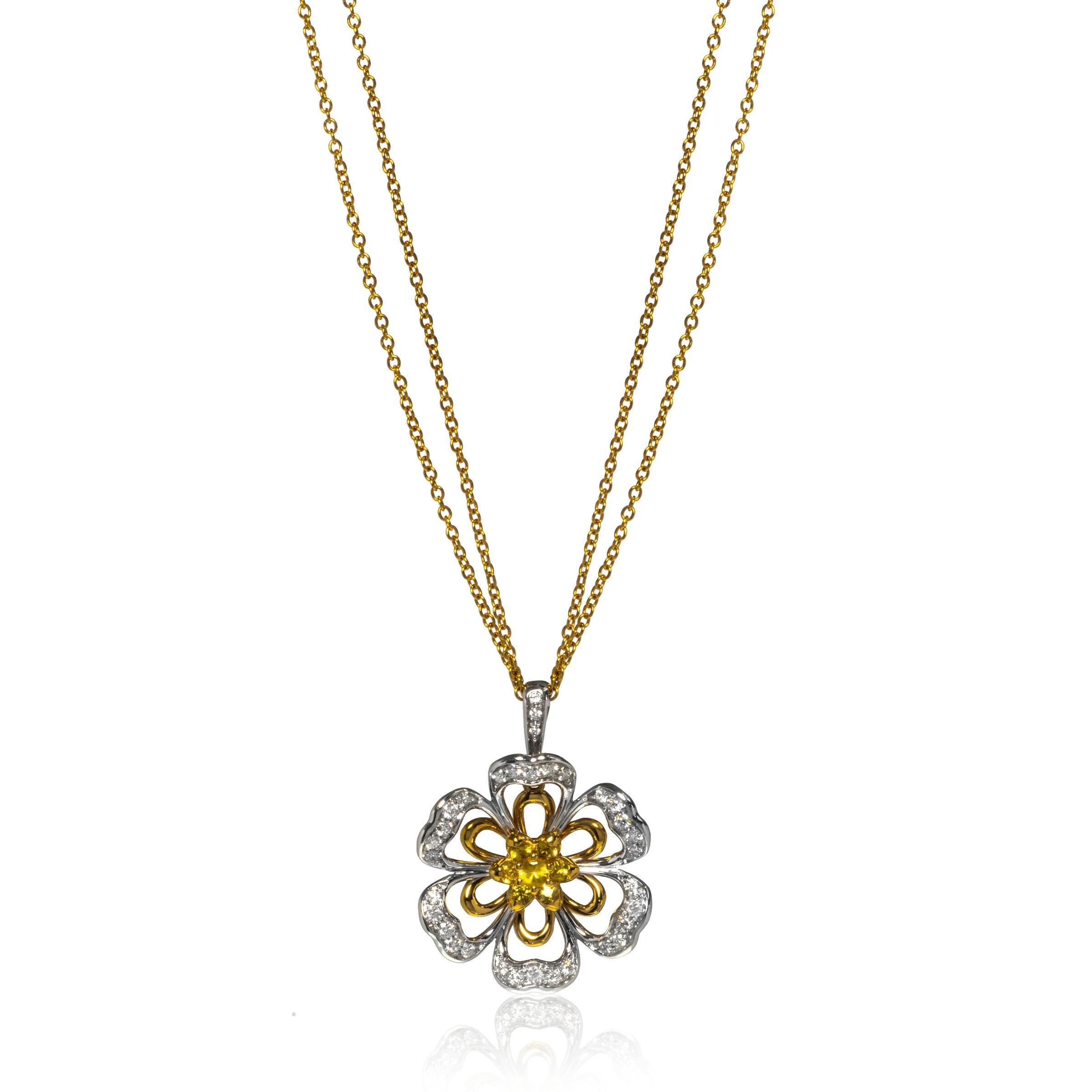 This beautiful Luca Carati 18k yellow and white gold pendant necklace features a gorgeous display of diamonds weighing 1.11cttw and Yellow sapphires weighing 0.59cttw in flower shape design. An 18k white gold floral setting overlaid on the yellow
