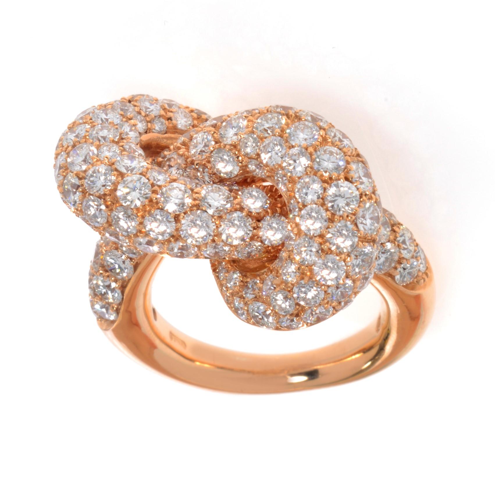 This chic jewelry piece is crafted in 18k rose gold with high polished smooth finish illuminating tons of shine and brilliance. Perfectly designed interlacing lines are creating a fabulous knot design adorned with 5.05cttw of genuine round cut