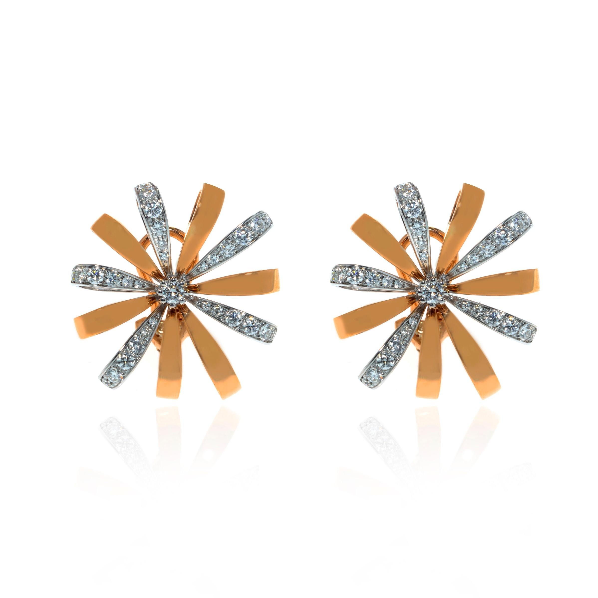 This gorgeous pair of estate earrings is finely crafted in solid 18K rose and white gold, made in the shape of beautiful flowers. The total diamond weight for the pair is 1.31 carats of VVS clarity and G color. Each earring measures 26mm. The