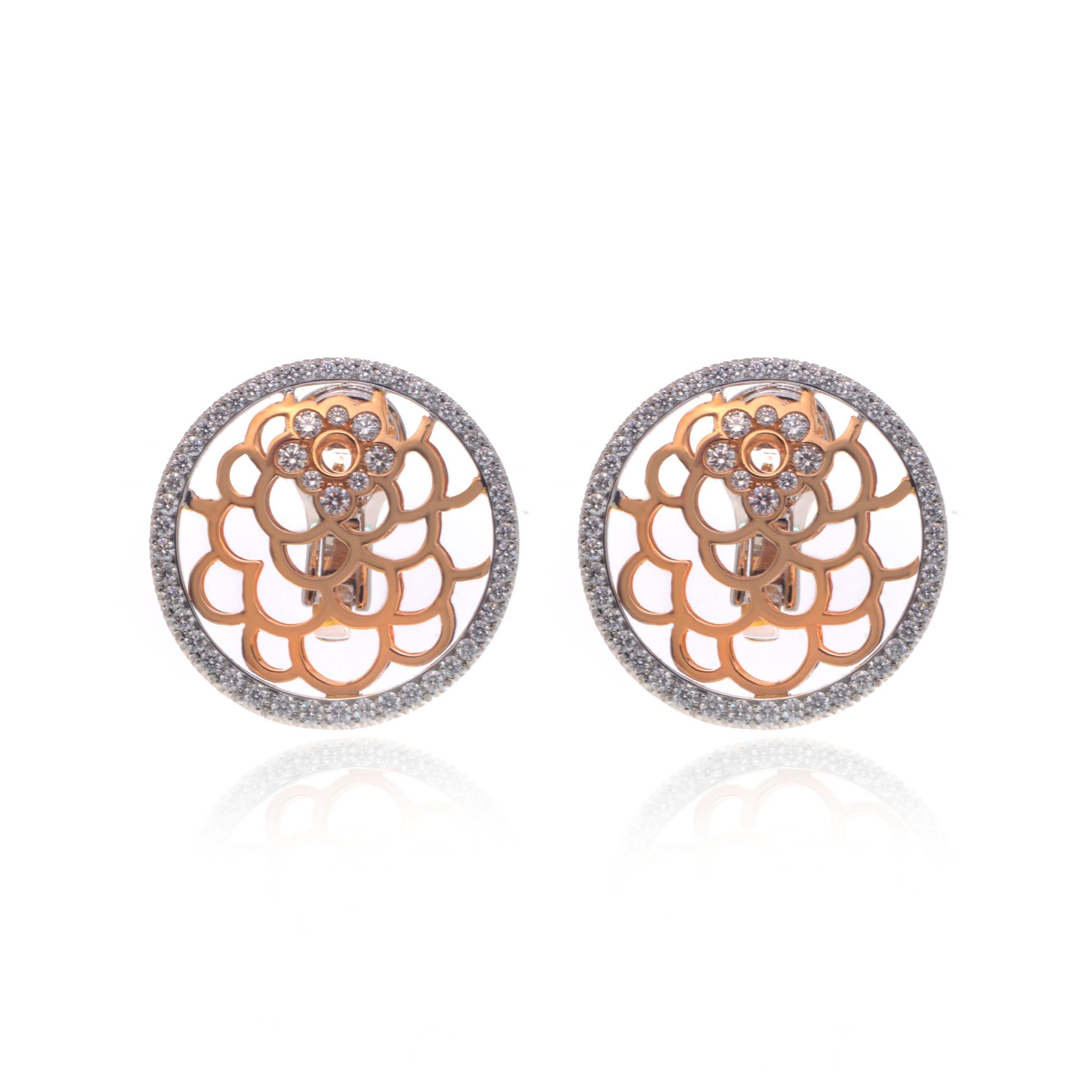 This gorgeous pair of estate earrings is finely crafted in solid 18K rose and white gold. Made in beautiful round floral design. The total diamond weight for the pair is 1.57 carats with VVS clarity and G color. Each earring measures 26mm. The