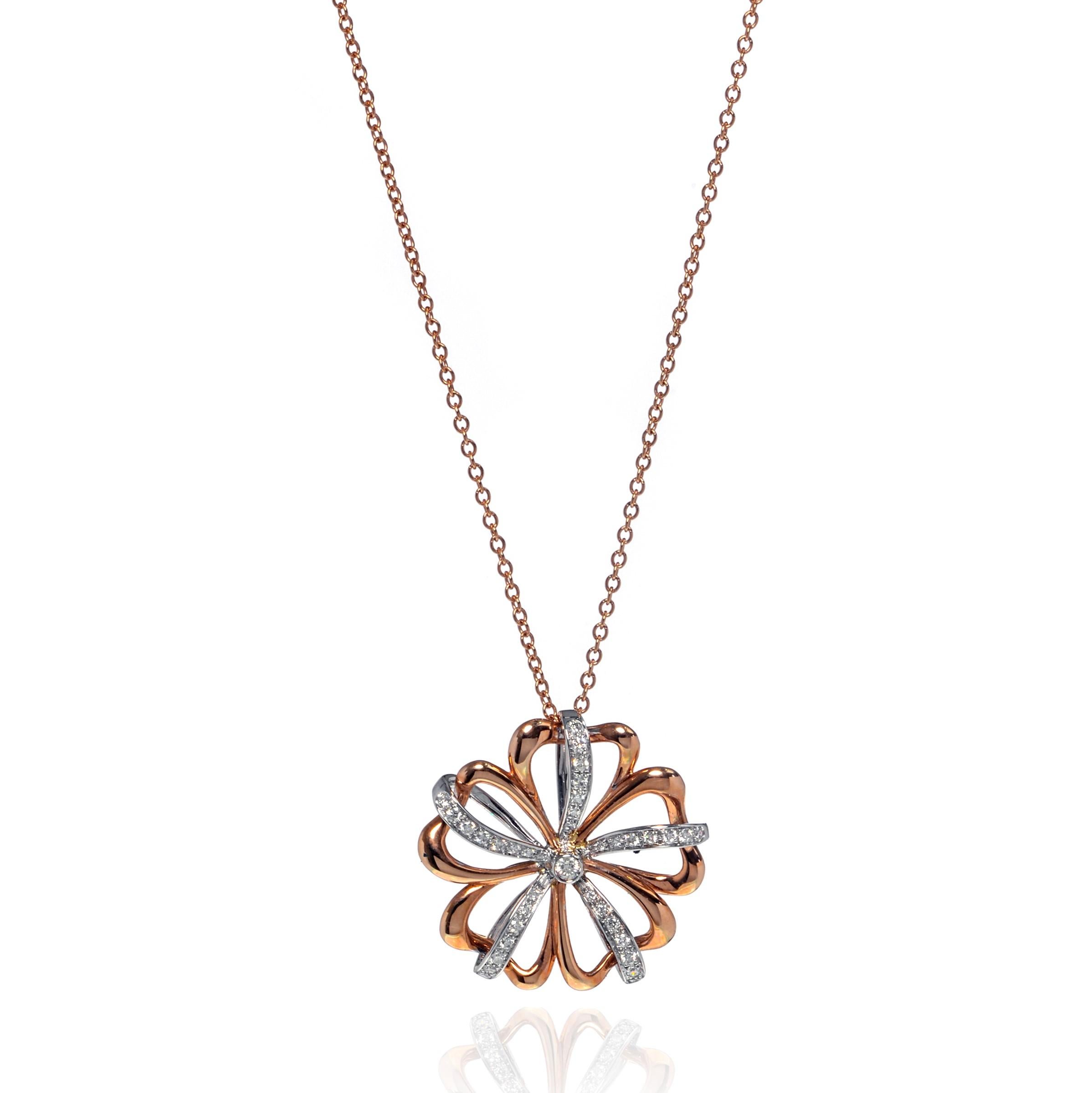 This beautiful Luca Carati 18k rose and white gold pendant necklace features a gorgeous display of diamonds 0.39cttw with a flower shaped design. An 18k white gold floral setting overlaid on an airy rose gold floral setting with a beautiful 18k rose