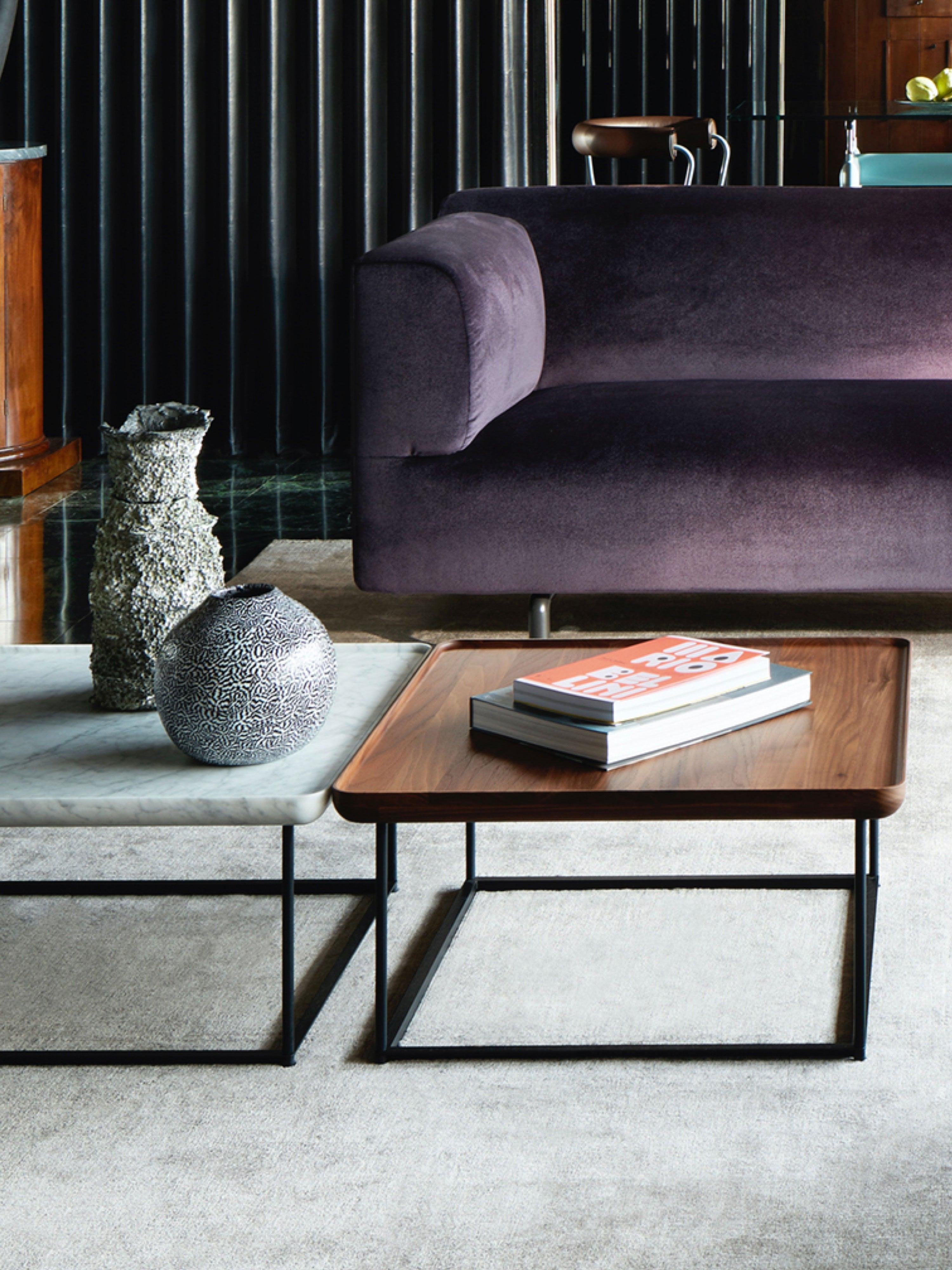 Named for the Japanese term for a tray, this table is designed to encourage hospitality and sharing. The walnut top has gently curved edges with a subtle lip and is supported by a sophisticated matte black metal base.

Cassina was established in