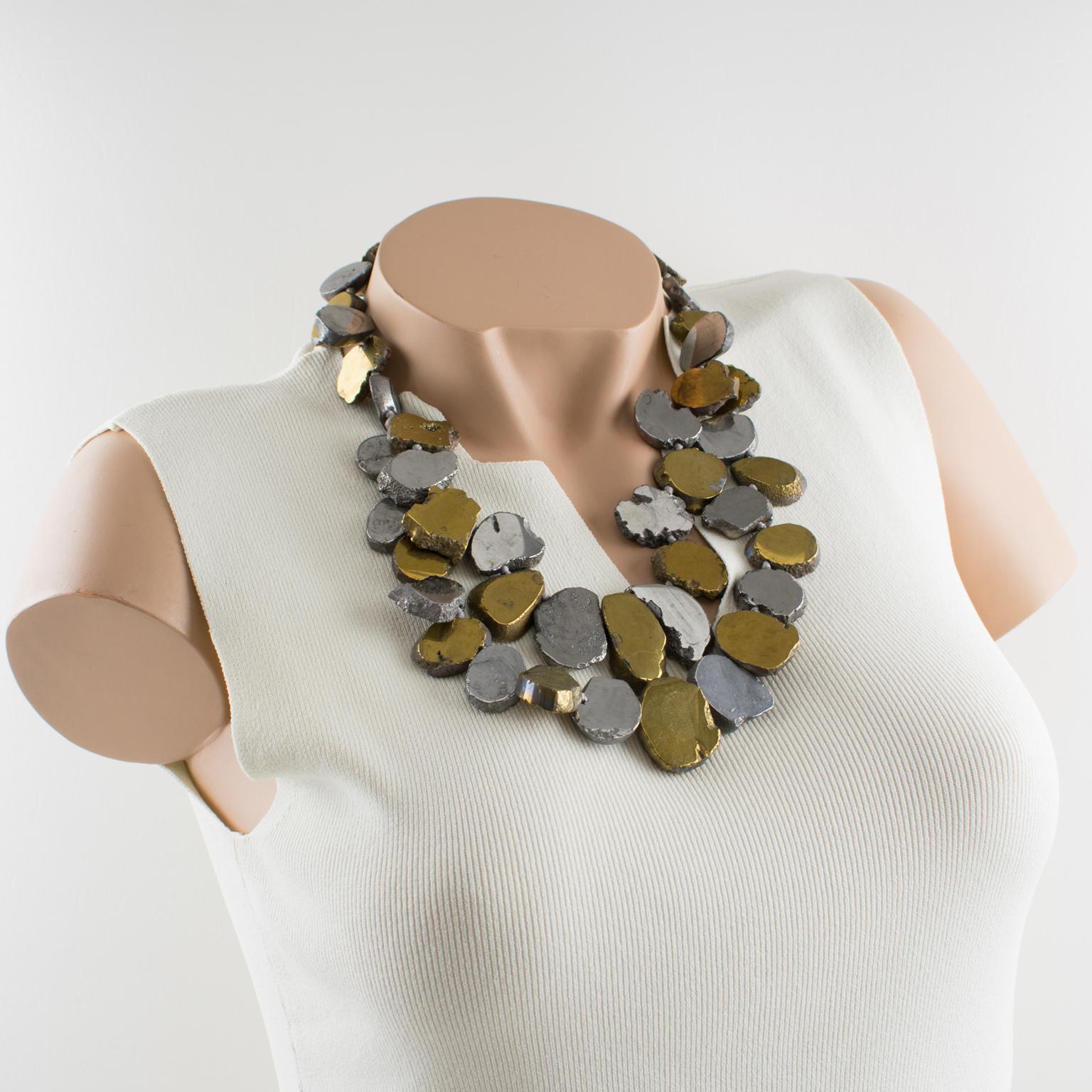 A stunning multi-row brutalist choker necklace designed by Lucas Lameth circa 2000. The necklace features flat chalcedony stone pebbles (agate, onyx, or marble) coated with gilded and silver metal. This double-strand necklace has a rough-hewn,