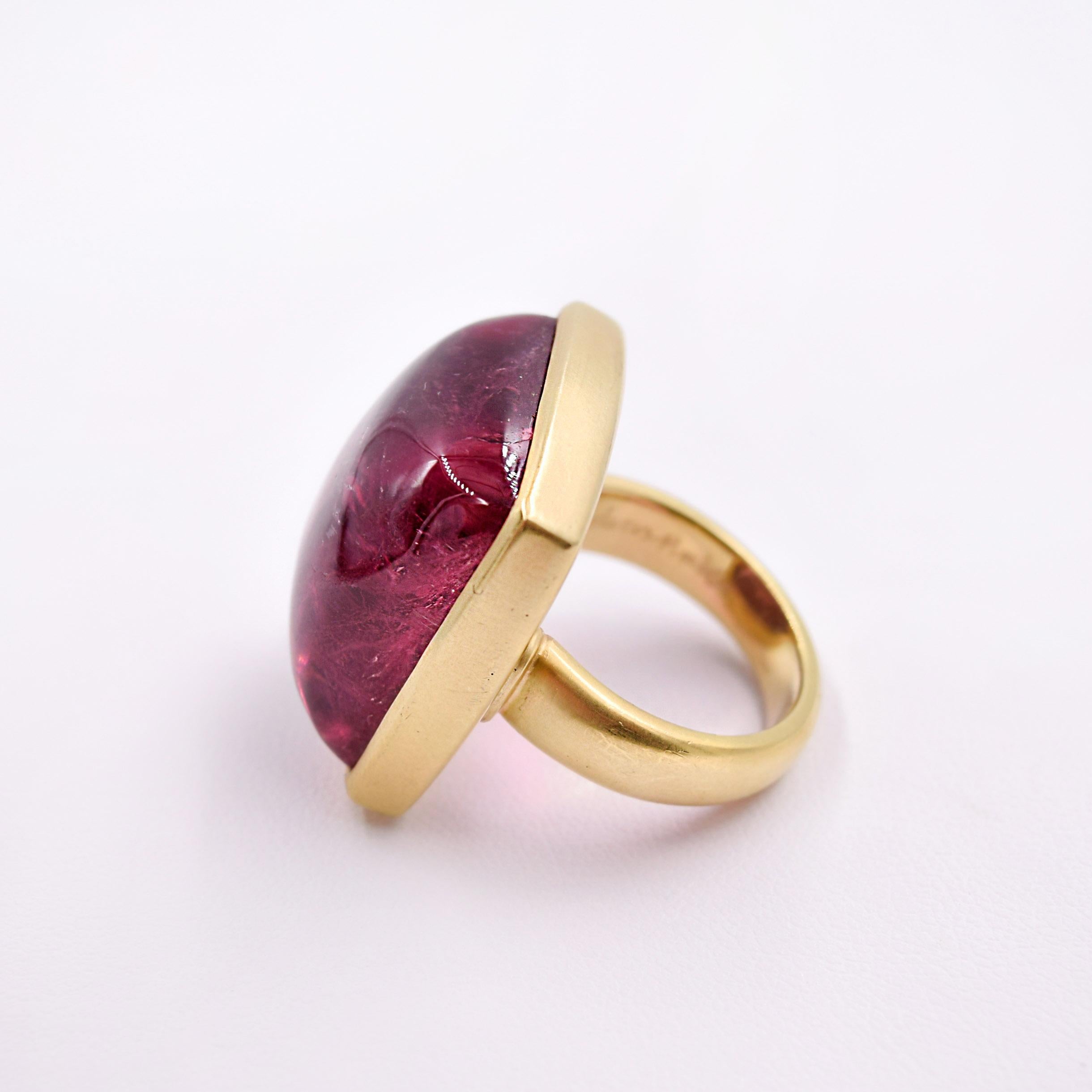 This 54.87ct Cabachon cut Pink Tourmaline Ring speaks for itself!
The Ring has been hand fabricated out of 18K Yellow Gold with a brushed finish, and was designed to be like a yummy piece of candy laying on a pillow of satin gold. 
Size 7 - can be